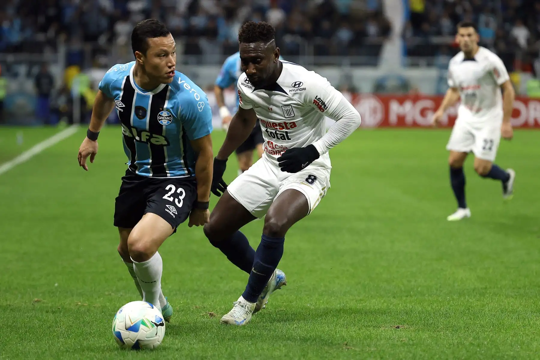 El defensa de Gremio, Marlon, y el mediocampista ecuatoriano de Alianza Lima, Eryc Castillo, disputan el balón durante el partido de eliminatoria de la Copa Sudamericana entre Gremio de Brasil y Alianza Lima de Perú en el estadio Arena do Gremio en Porto Alegre. Foto: ANDINA/ AFP