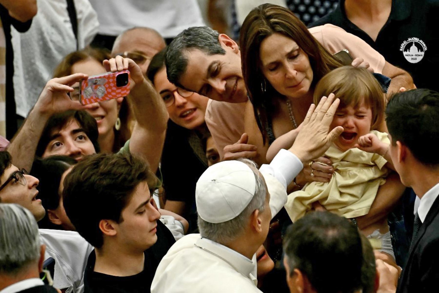 El Papa León XIV bendice a una familia durante la audiencia general en el Aula Pablo VI del Vaticano. Foto: AFP