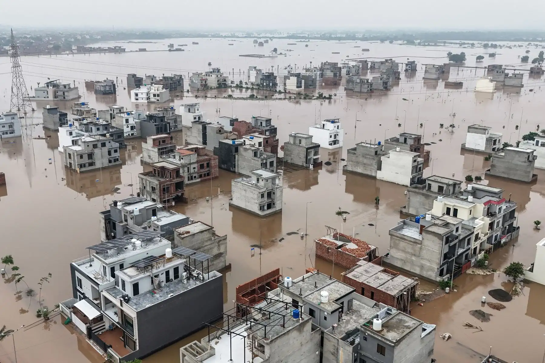 Esta vista aérea muestra edificios residenciales parcialmente sumergidos luego del desbordamiento del río Ravi en Lahore. Las lluvias monzónicas de esta semana hicieron crecer tres ríos transfronterizos que atraviesan la provincia oriental de Pakistán, el corazón agrícola del país y hogar de casi la mitad de sus 255 millones de habitantes.
Foto: AFP