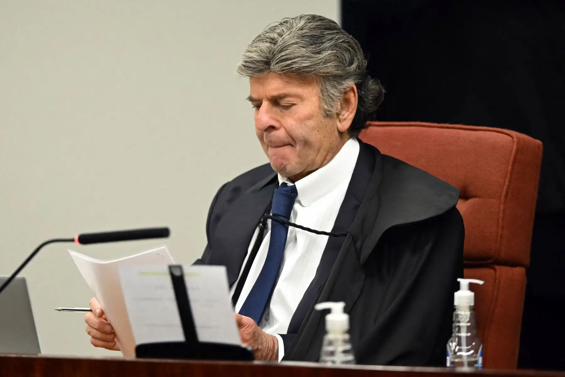 El ministro del Supremo Tribunal Federal de Brasil, Luiz Fux, lee un documento durante la sesión de votación para condenar al expresidente de Brasil (2019-2022), Jair Bolsonaro, en un juicio por golpe de Estado en el Supremo Tribunal Federal en Brasilia el 11 de septiembre de 2025. Foto: AFP