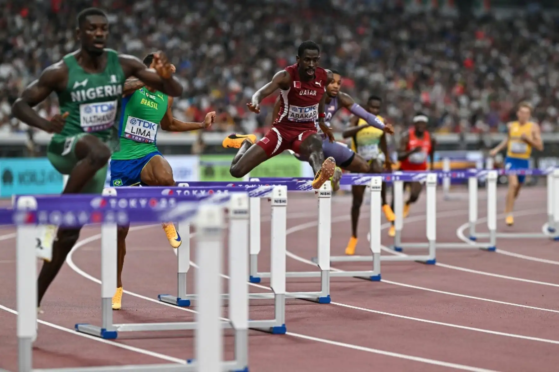 El nigeriano Ezekiel Nathaniel, el brasileño Matheus Lima y el catarí Ismail Doudai Abakar compiten en la semifinal masculina de los 400 m vallas durante el Campeonato Mundial de Atletismo en Tokio. Foto: AFP