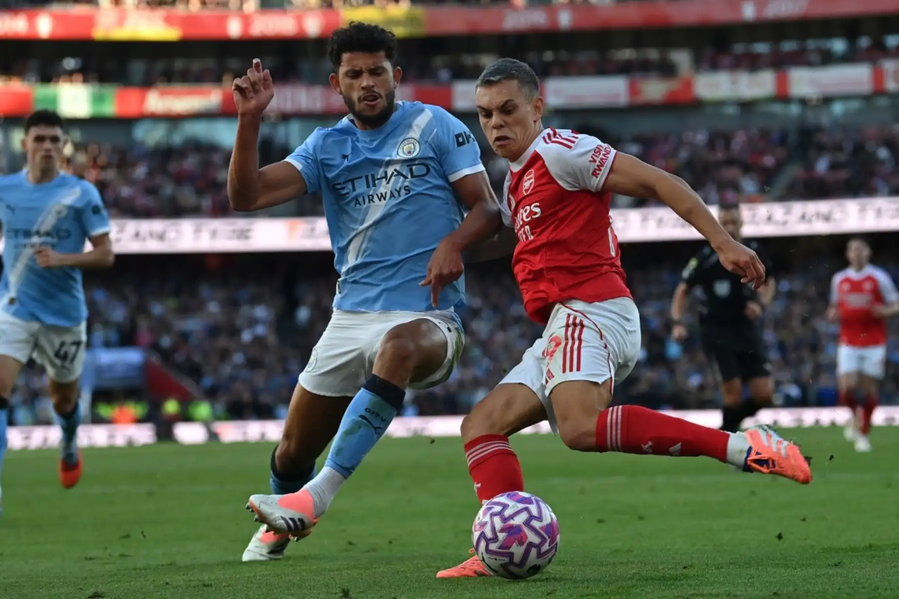 El centrocampista portugués del Manchester City, Matheus Nunes, compite con el centrocampista belga del Arsenal, Leandro Trossard, durante el partido de fútbol de la Premier League inglesa entre el Arsenal y el Manchester City en el Emirates Stadium en Londres el 21 de septiembre de 2025. Foto: AFP