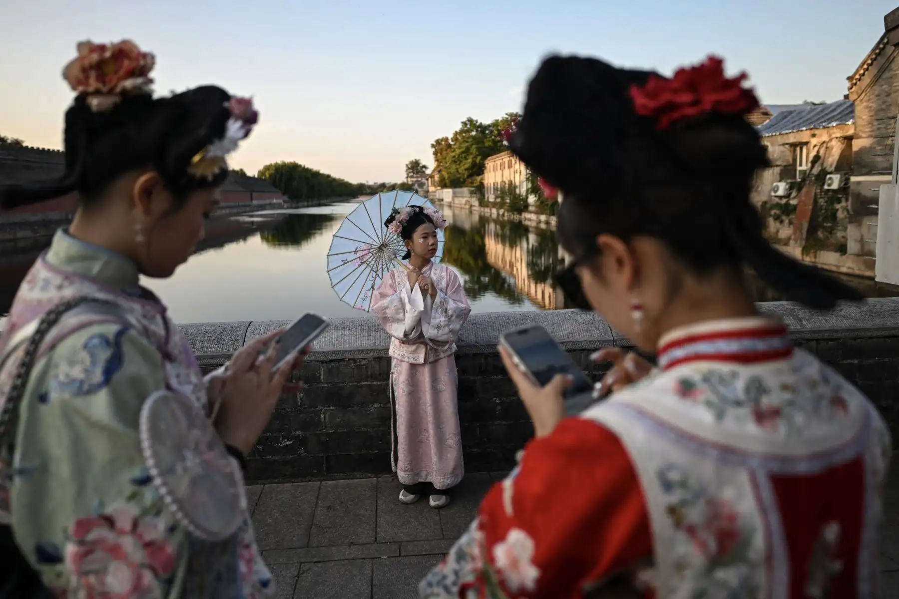 Mujeres con trajes tradicionales chinos posan para fotografías mientras visitan los alrededores de la Ciudad Prohibida en Beijing durante las vacaciones de la Semana Dorada del Día Nacional de China.
Foto: AFP