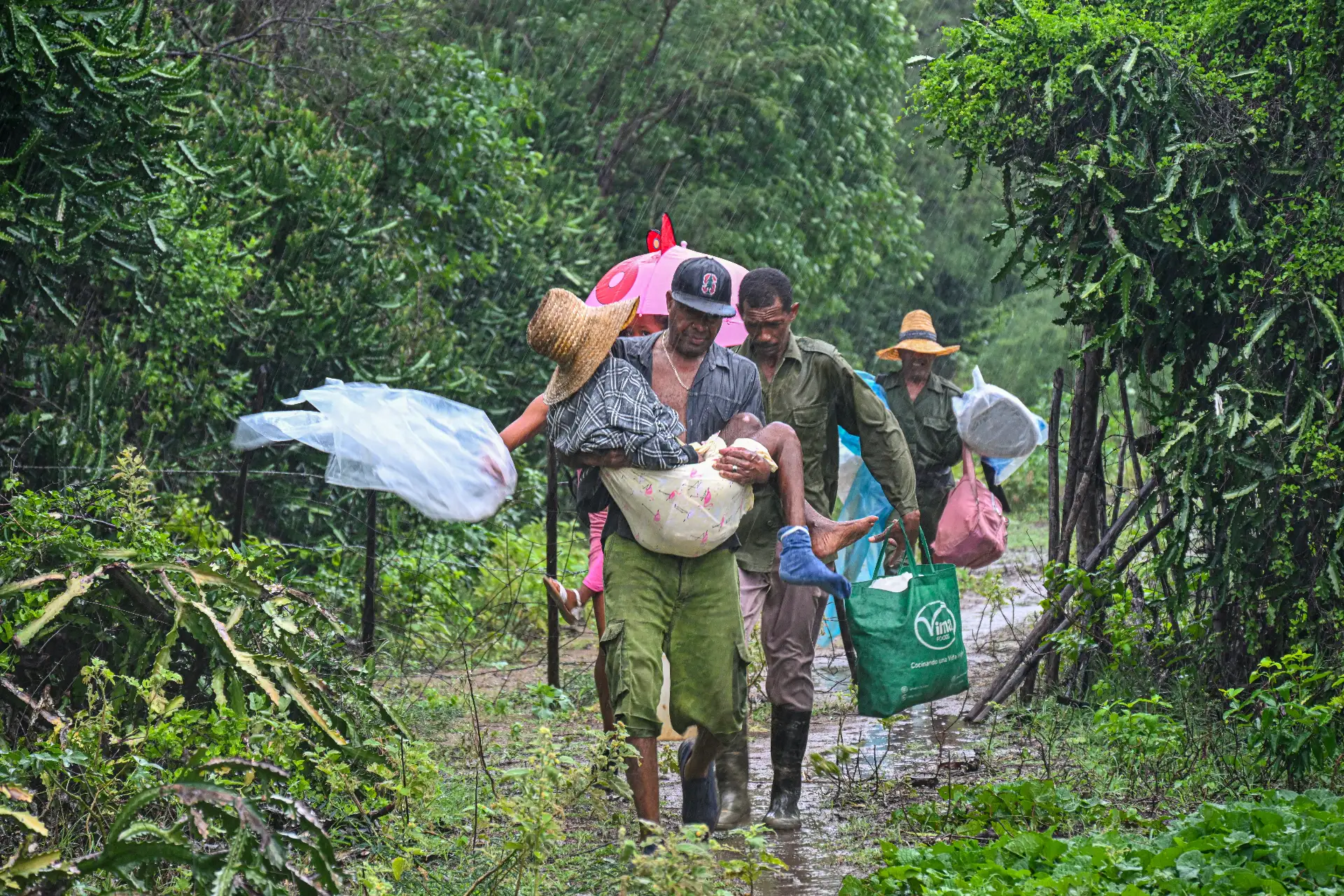 Residentes autoevacúan bajo fuertes lluvias de playa Siboney hacia lugares seguros ante la llegada del huracán Melissa, en Santiago de Cuba. Foto: AFP