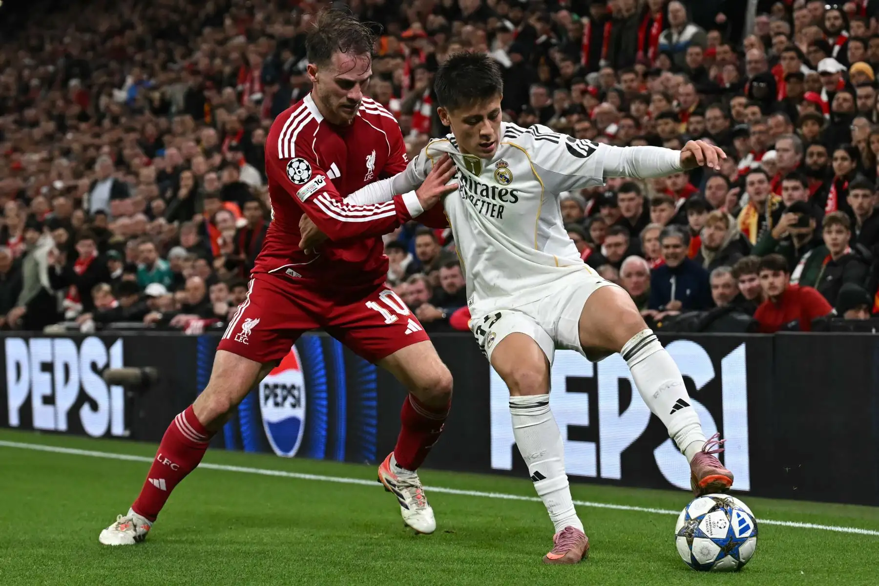 El centrocampista turco del Real Madrid, Arda Güler disputa el balón con el centrocampista argentino del Liverpool, Alexis Mac Allisterdurante el partido de la fase de grupos de la UEFA Champions League entre el Liverpool y el Real Madrid. AFP