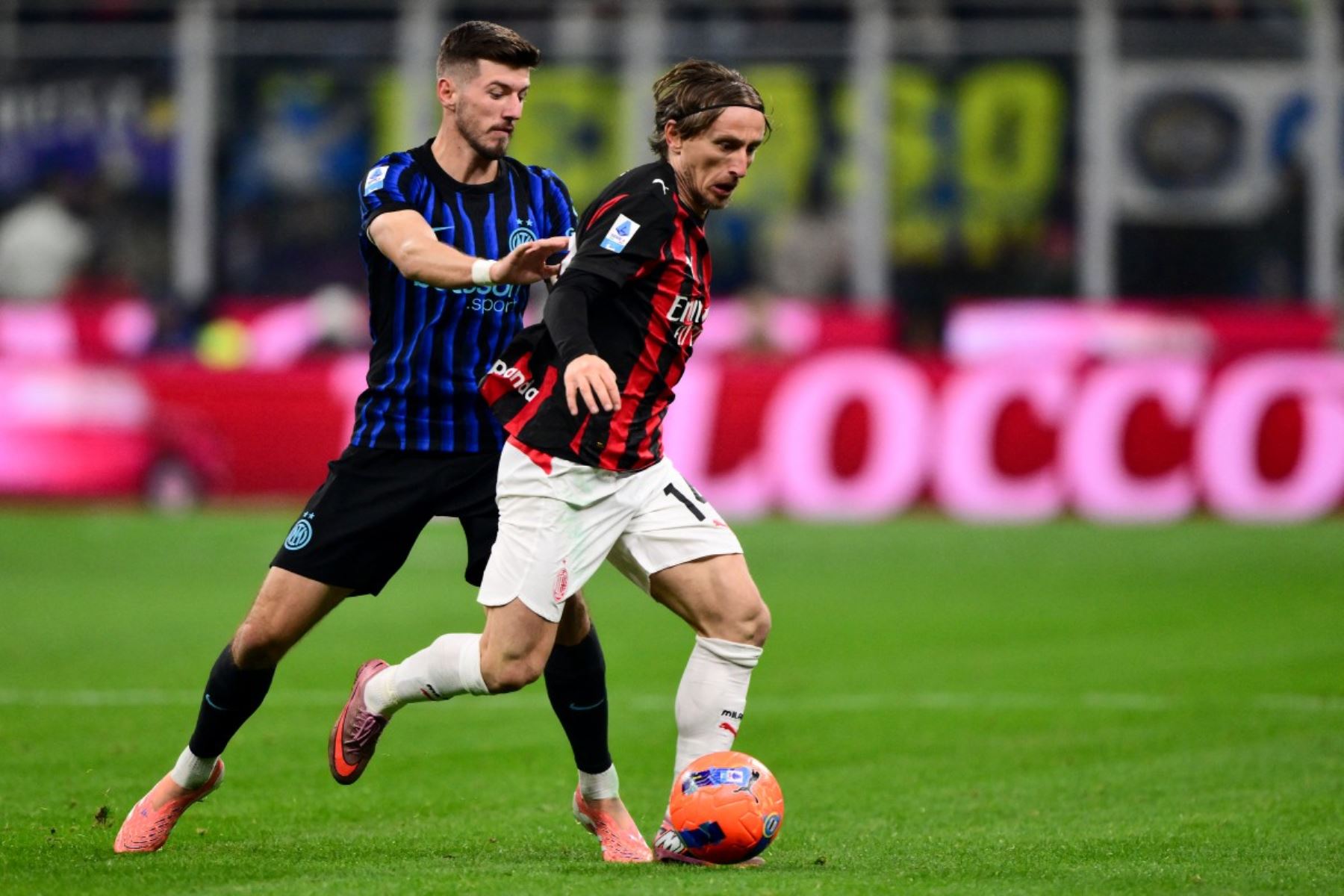 El delantero austriaco del Inter de Milán #08 Marko Arnautovic (L) y el centrocampista croata del AC Milan #14 Luka Modric compiten por el balón durante el partido de fútbol italiano de la Serie A entre el Inter de Milán y el AC Milán en el estadio San Siro en Milán, norte de Italia, el 23 de noviembre de 2025. (Foto de Marco BERTORELLO / AFP)