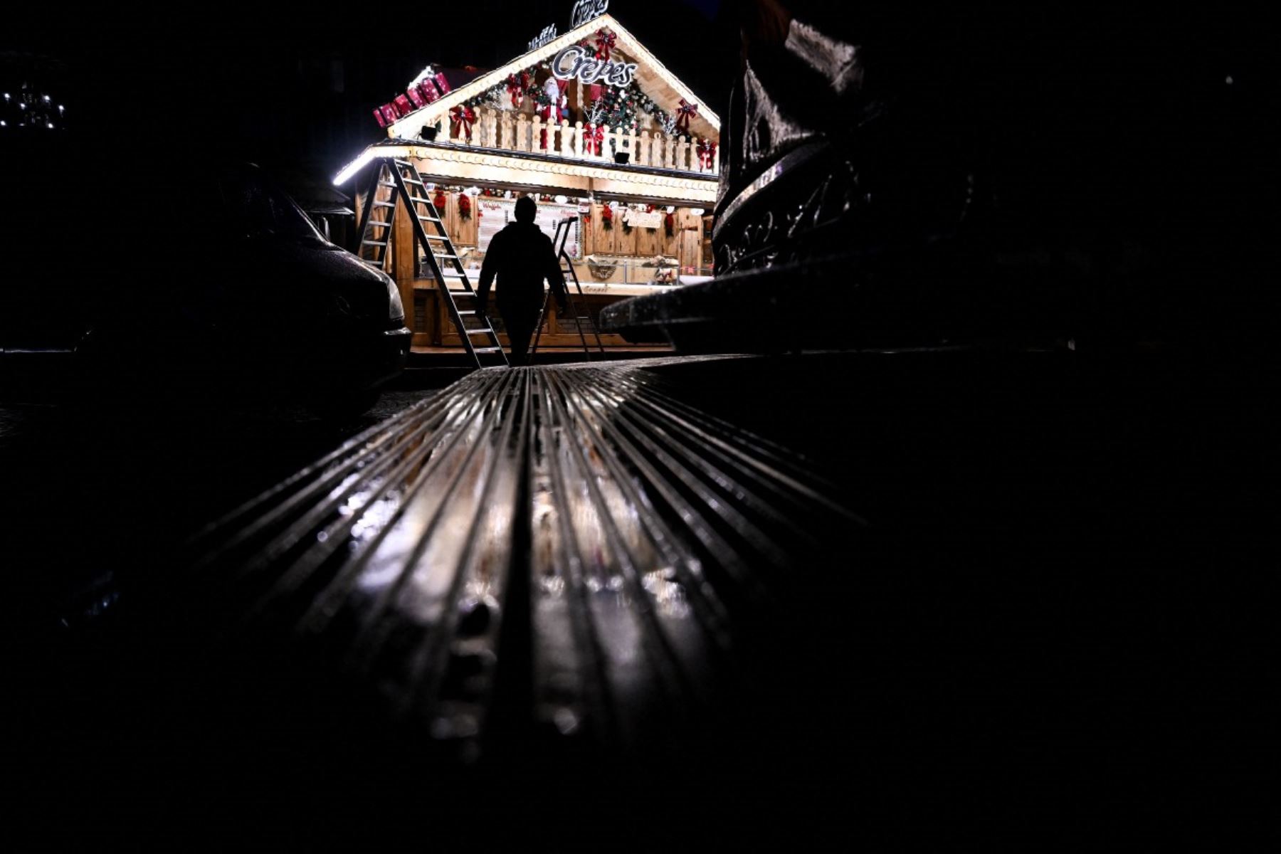 Las luces de un puesto recién instalado con adornos navideños se reflejan en la céntrica plaza Roemer de Frankfurt am Main, en el oeste de Alemania.  Foto: AFP