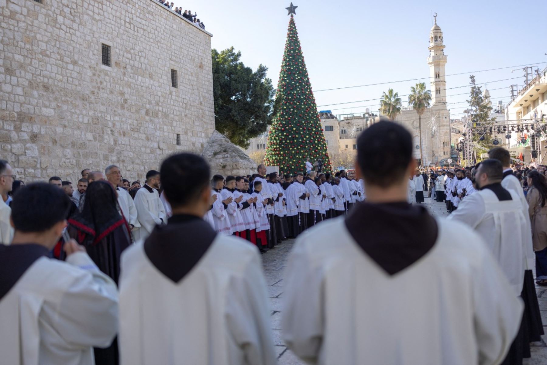 Miembros del clero participan en la procesión navideña anual encabezada por el Patriarca Latino de Jerusalén frente a la Iglesia de la Natividad en la ciudad de Belén, en Cisjordania ocupada por Israel. AFP