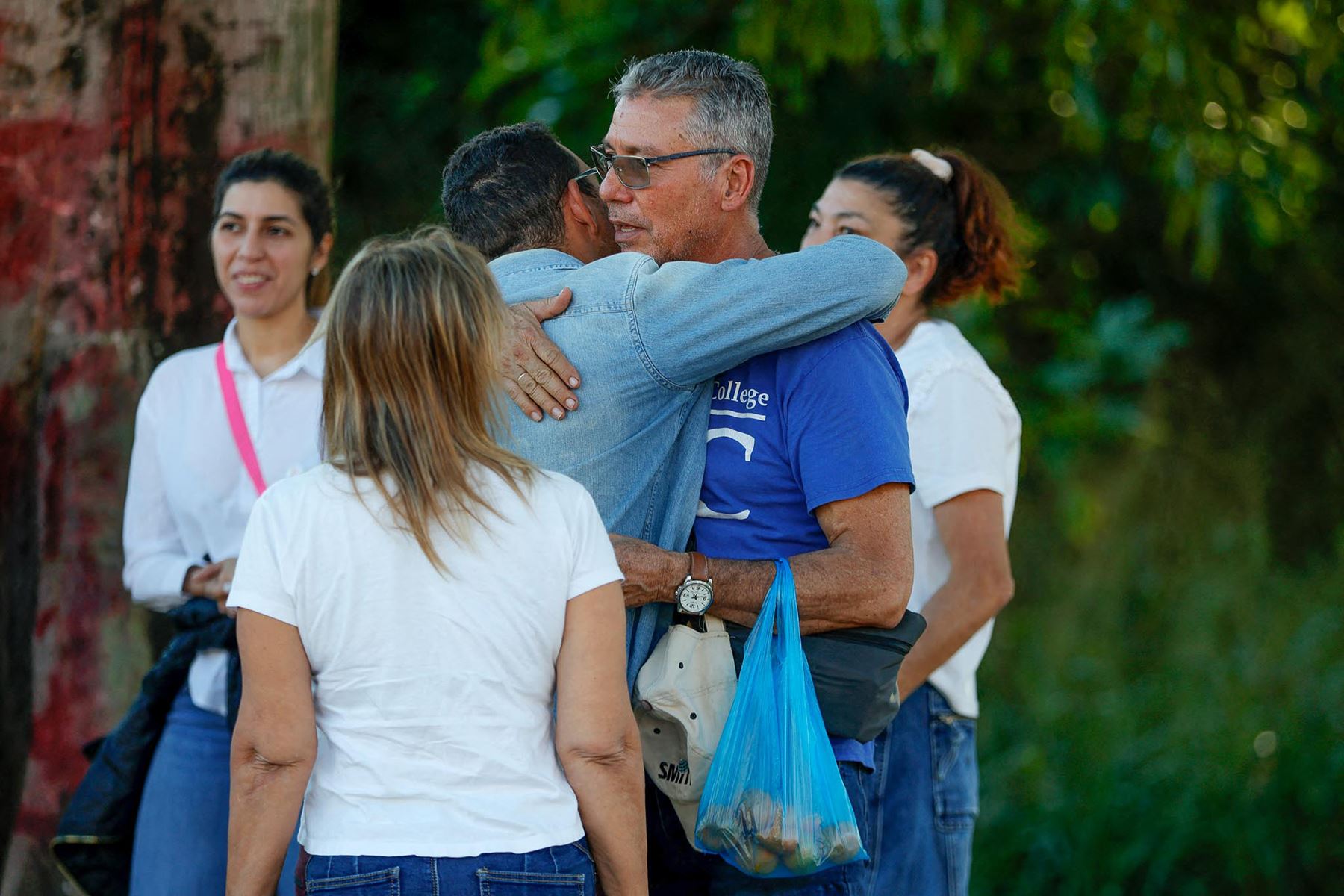 Familiares de presos se abrazan mientras esperan frente a la cárcel de El Rodeo en Caracas. Foto: AFP