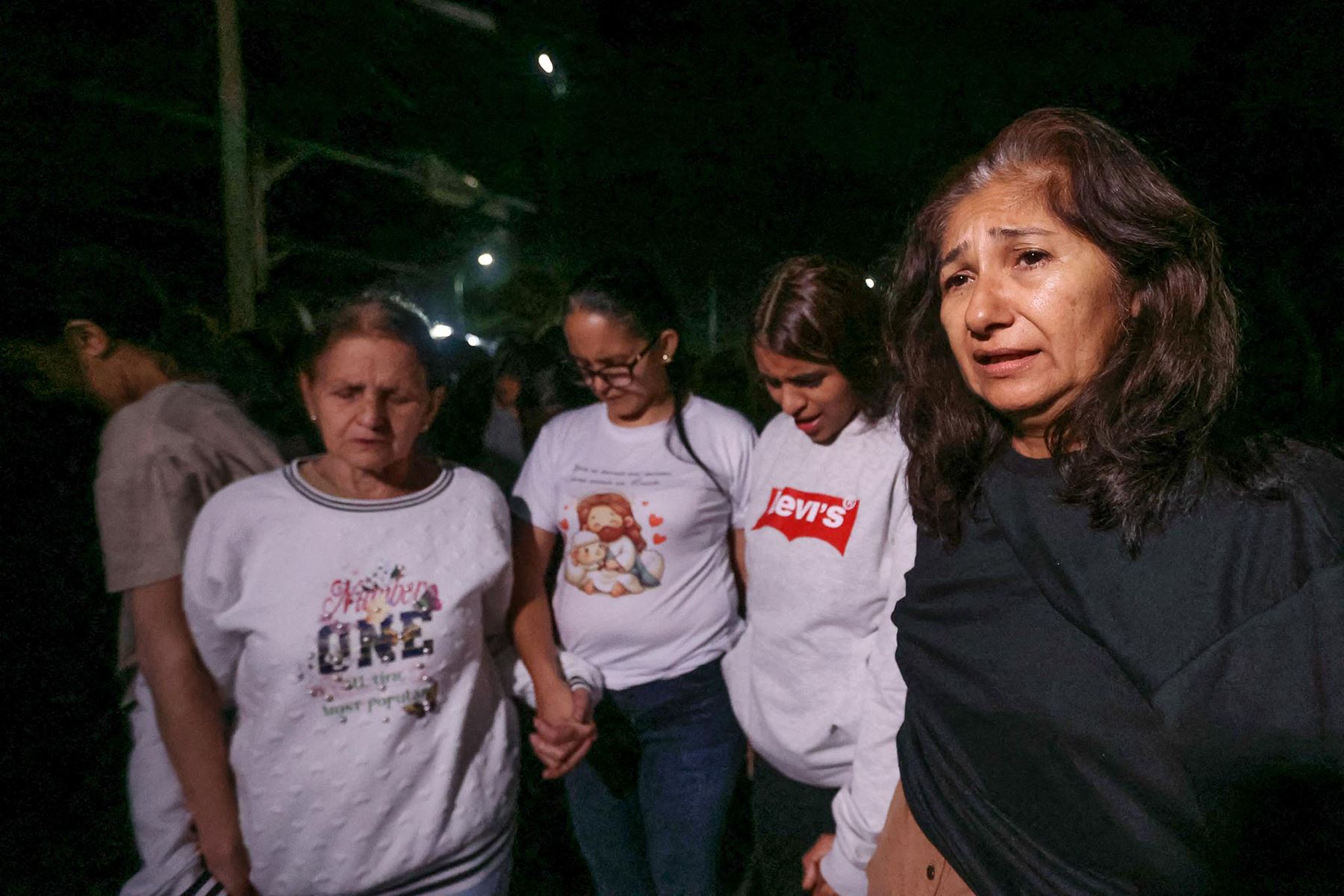 Familiares de presos participan en una oración mientras esperan frente a la cárcel de El Rodeo en Caracas.  Las autoridades venezolanas están liberando a un gran número de presos, según declaró el presidente del parlamento venezolano, Jorge Rodríguez. Foto: AFP