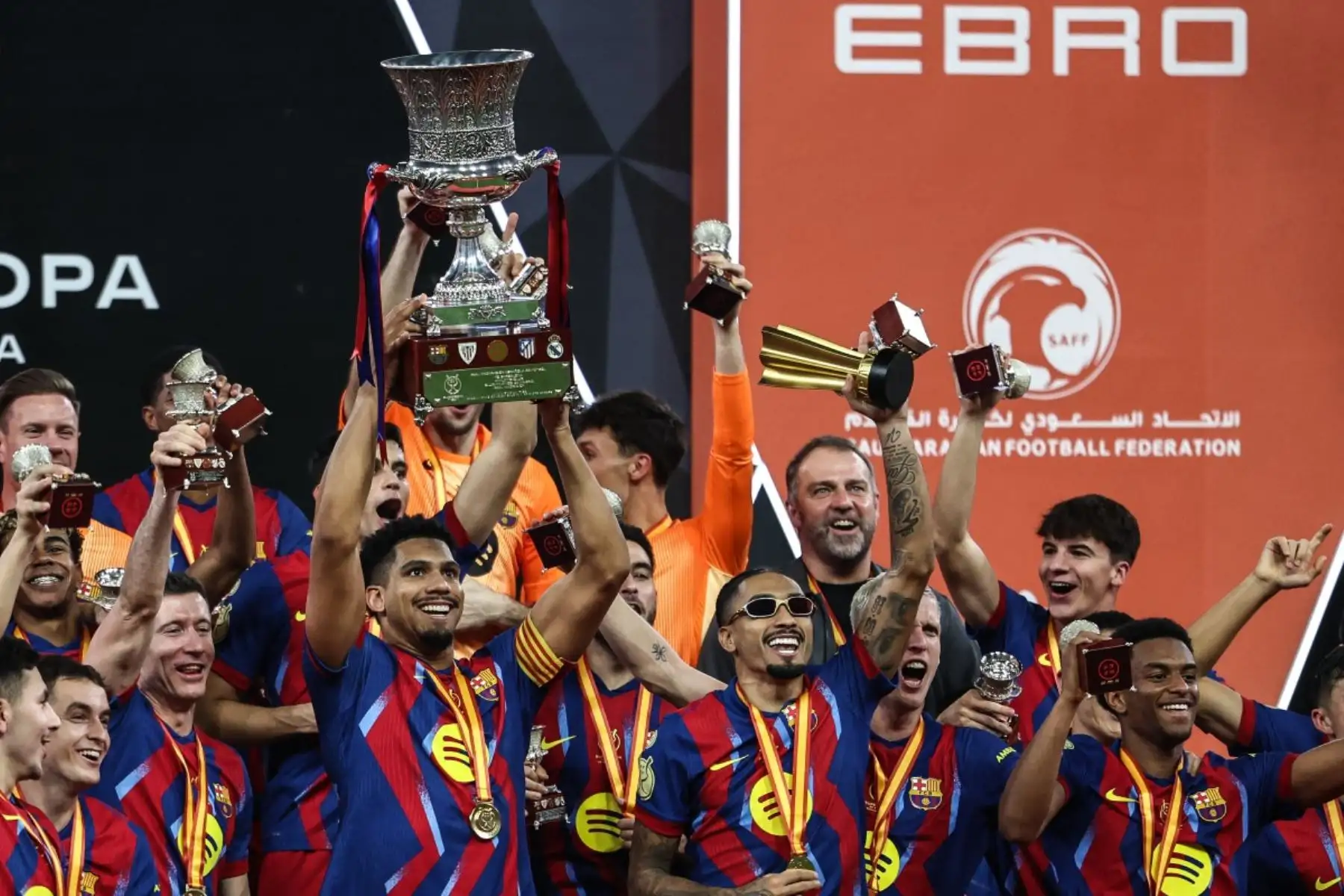 Los jugadores del Barcelona levantan el trofeo mientras celebran tras ganar la final de la Supercopa de España entre el FC Barcelona y el Real Madrid en el Estadio Rey Abdullah en Yeddah.
Foto: AFP