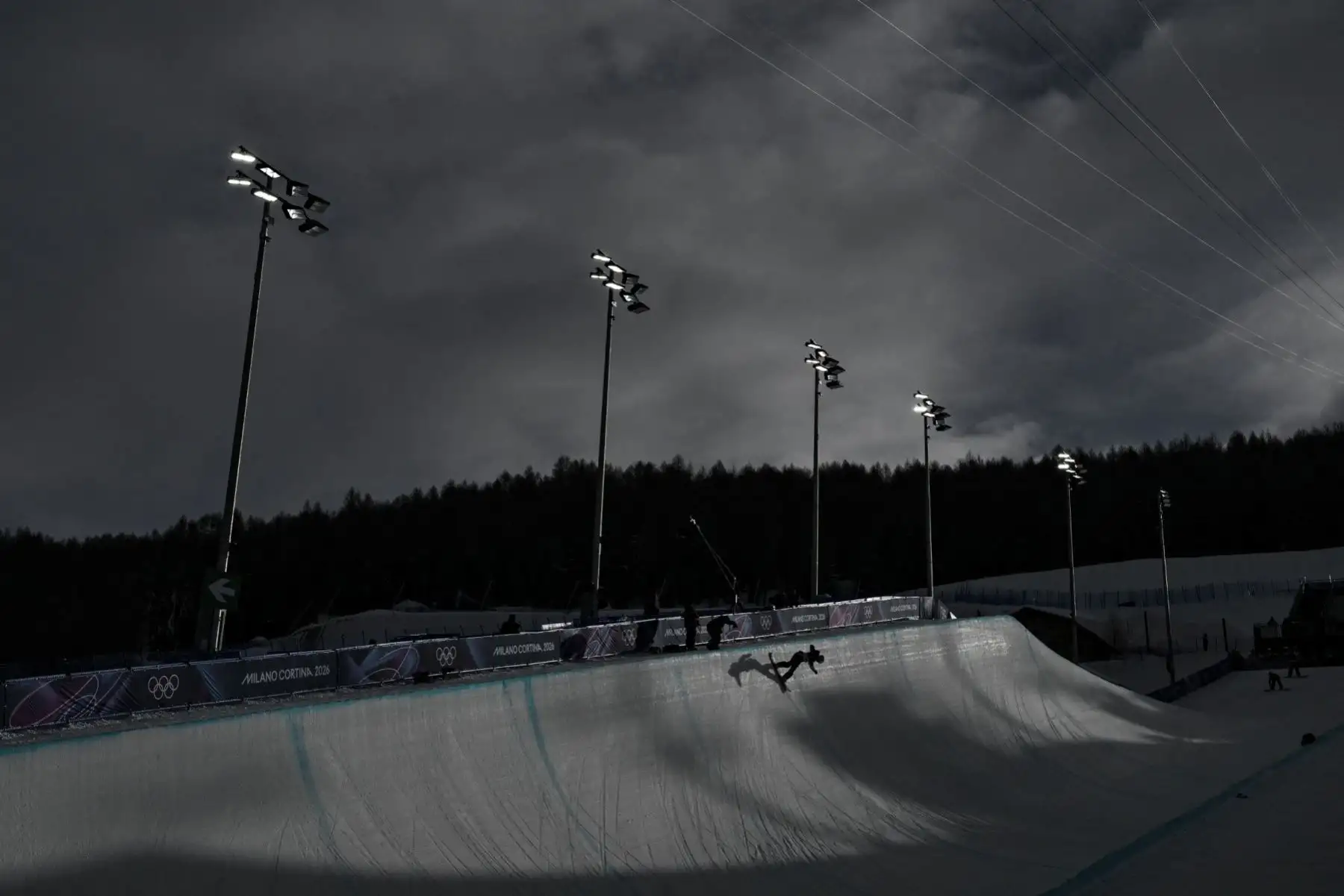 Una competidora calienta antes de la primera manga de clasificación de halfpipe femenino de snowboard durante los Juegos Olímpicos de Invierno Milano Cortina 2026 en el Snowpark de Livigno, en Livigno (Valtellina), el 11 de febrero de 2026. Foto: AFP
