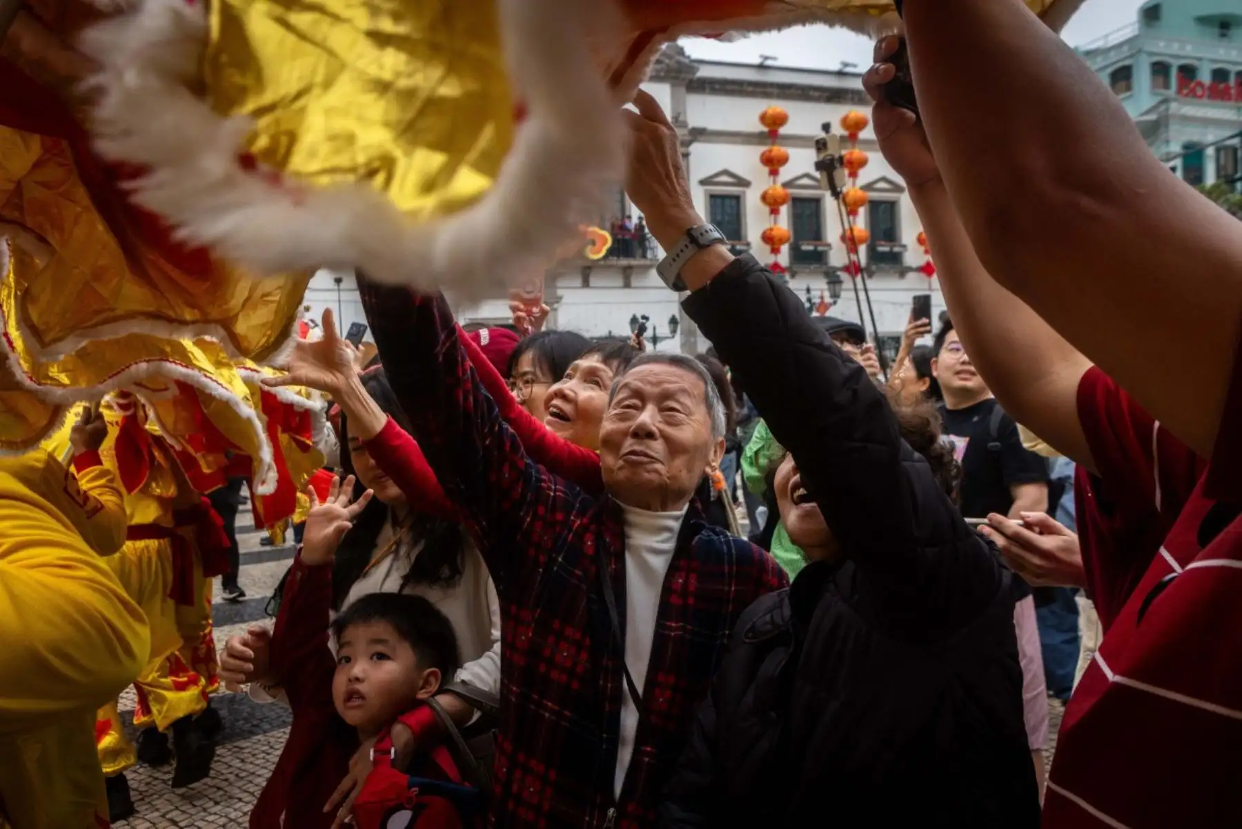 La gente toca al dragón para tener buena suerte frente a las ruinas de San Pablo durante las celebraciones del primer día del Año Nuevo Lunar del Caballo en Macao. Foto: AFP