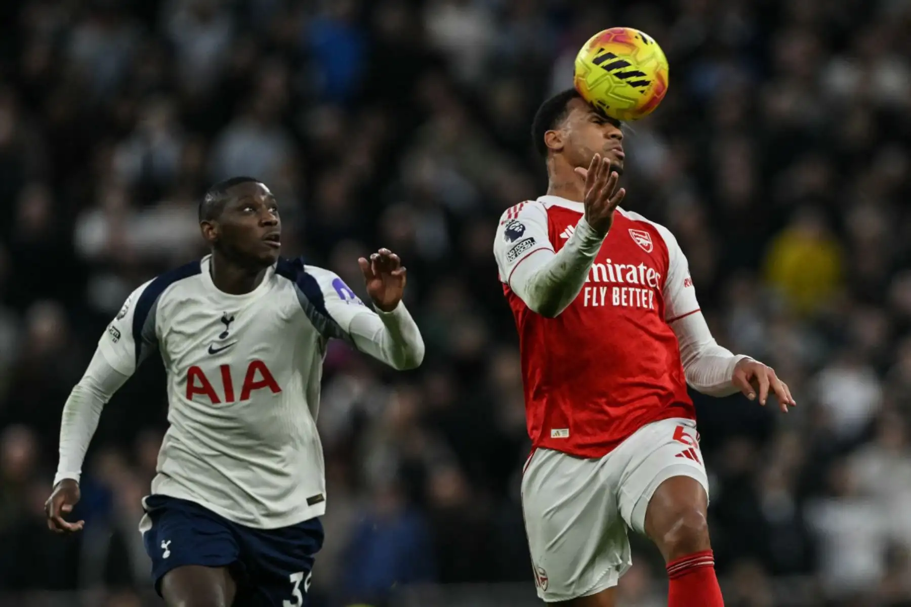El delantero francés del Tottenham Hotspur Randal Kolo Muani observa mientras el defensa brasileño del Arsenal Gabriel Magalhaes cabecea el balón durante el partido de la Premier League inglesa entre el Tottenham Hotspur y el Arsenal en el Tottenham Hotspur Stadium en Londres. Foto: ANDINA/AFP