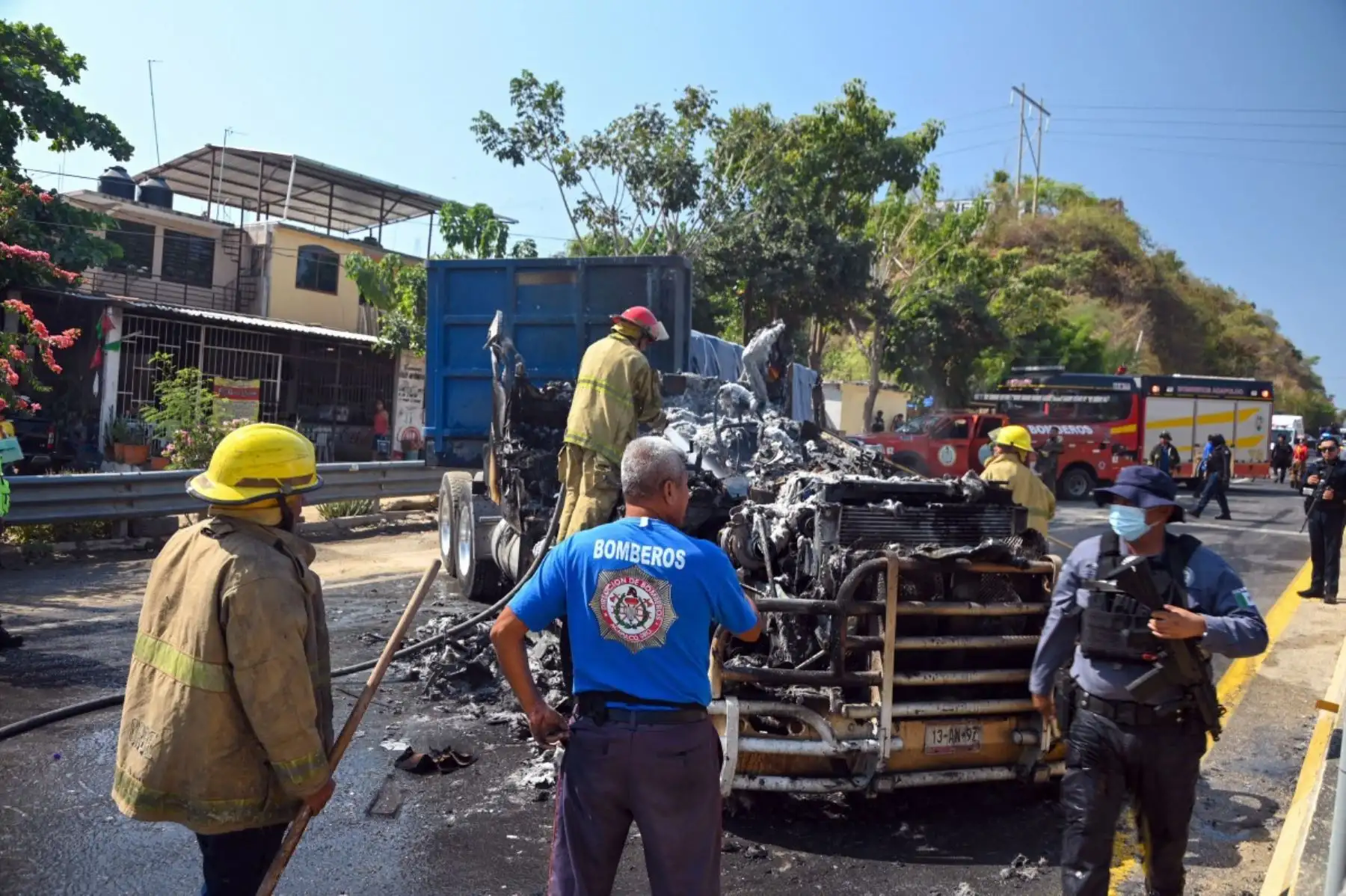 Los bomberos extinguen un camión incendiado que fue incendiado en una calle del puerto de Acapulco, estado de Guerrero, México, el 22 de febrero de 2026. El poderoso líder del cártel de la droga Nemesio Oseguera murió el 22 de febrero por las heridas sufridas en una redada de las fuerzas de seguridad, dijo el ejército. Foto: AFP