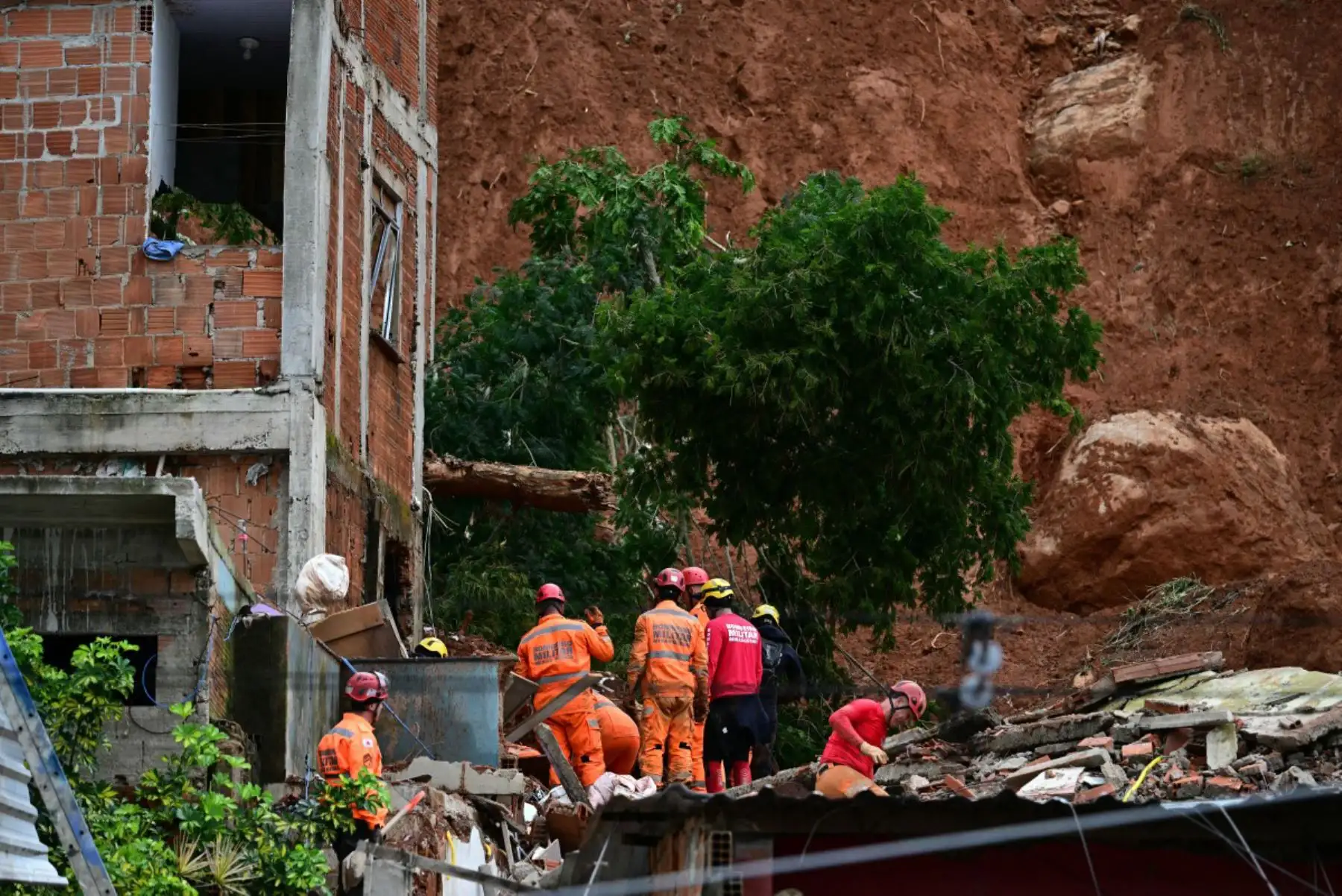 Equipos de rescate retiran escombros en busca de víctimas de un deslizamiento de tierra causado por las fuertes lluvias en el Barrio Parque Jardim Burnier, en Juiz de Fora, Minas Gerais, Brasil. Las lluvias torrenciales en el sureste de Brasil han dejado al menos 23 muertos y 47 desaparecidos en inundaciones y deslizamientos de tierra. Foto: ANDINA/AFP