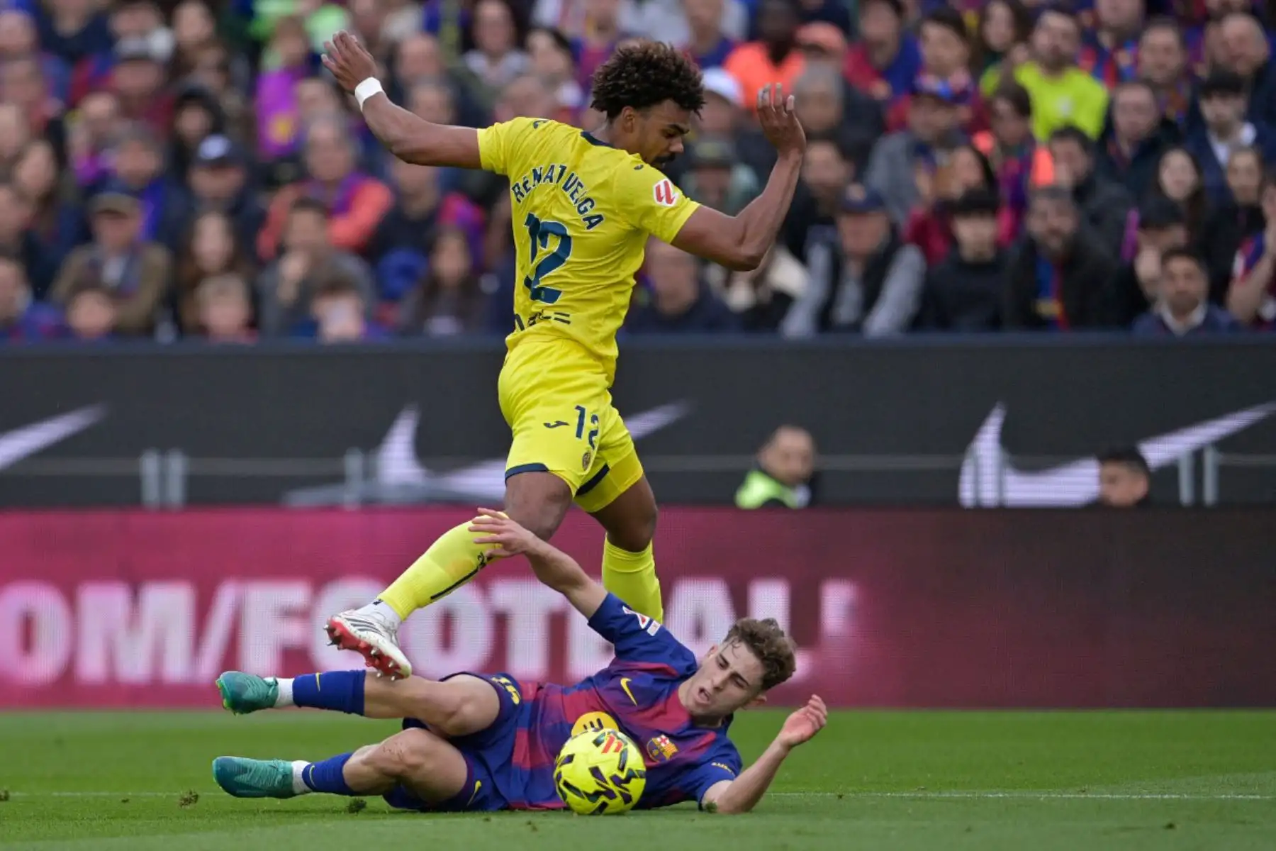 El defensa portugués del Villarreal, Renato Veiga, salta sobre el mediocampista español del Barcelona, ​​Fermín López, durante el partido de la liga española entre el FC Barcelona y el Villarreal CF.  Foto: ANDINA/AFP