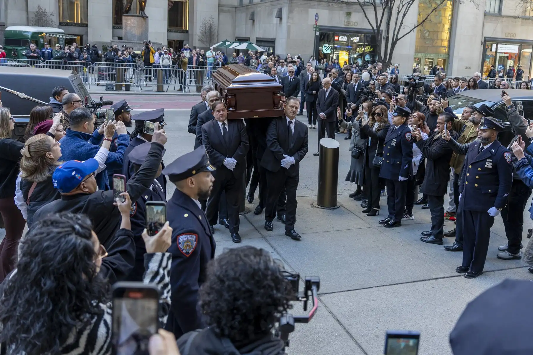 Personas sostienen el féretro del cantante Willie Colón este lunes, al finalizar una misa pública en la Catedral de San Patricio en Nueva York  Foto: EFE