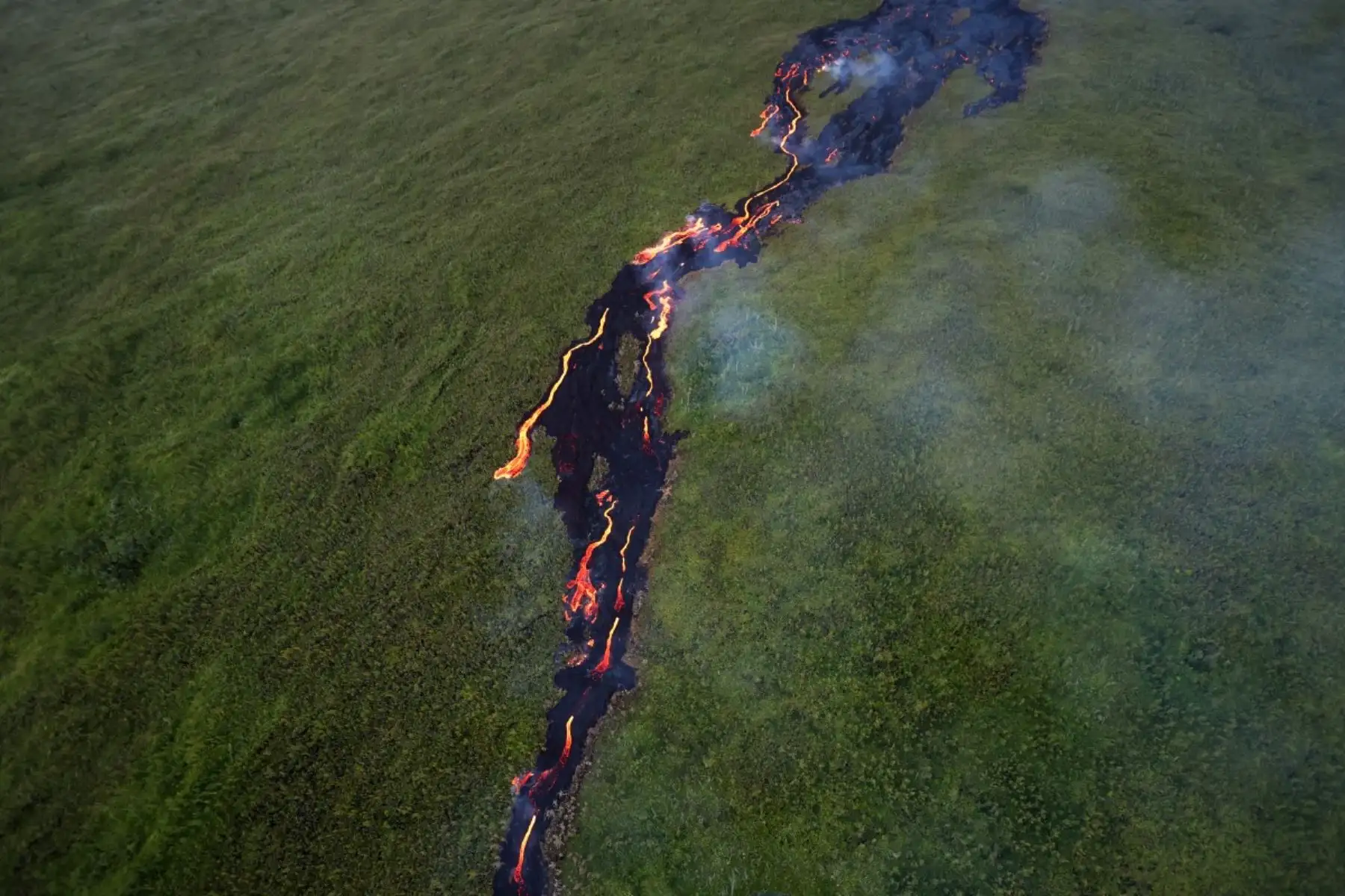 Flujo de lava abriéndose paso a través de una zona boscosa y cruzando la carretera RN2 cerca de Sainte-Rose, próxima al volcán Piton de la Fournaise, en el sureste de la isla francesa de La Reunión. Foto: AFP