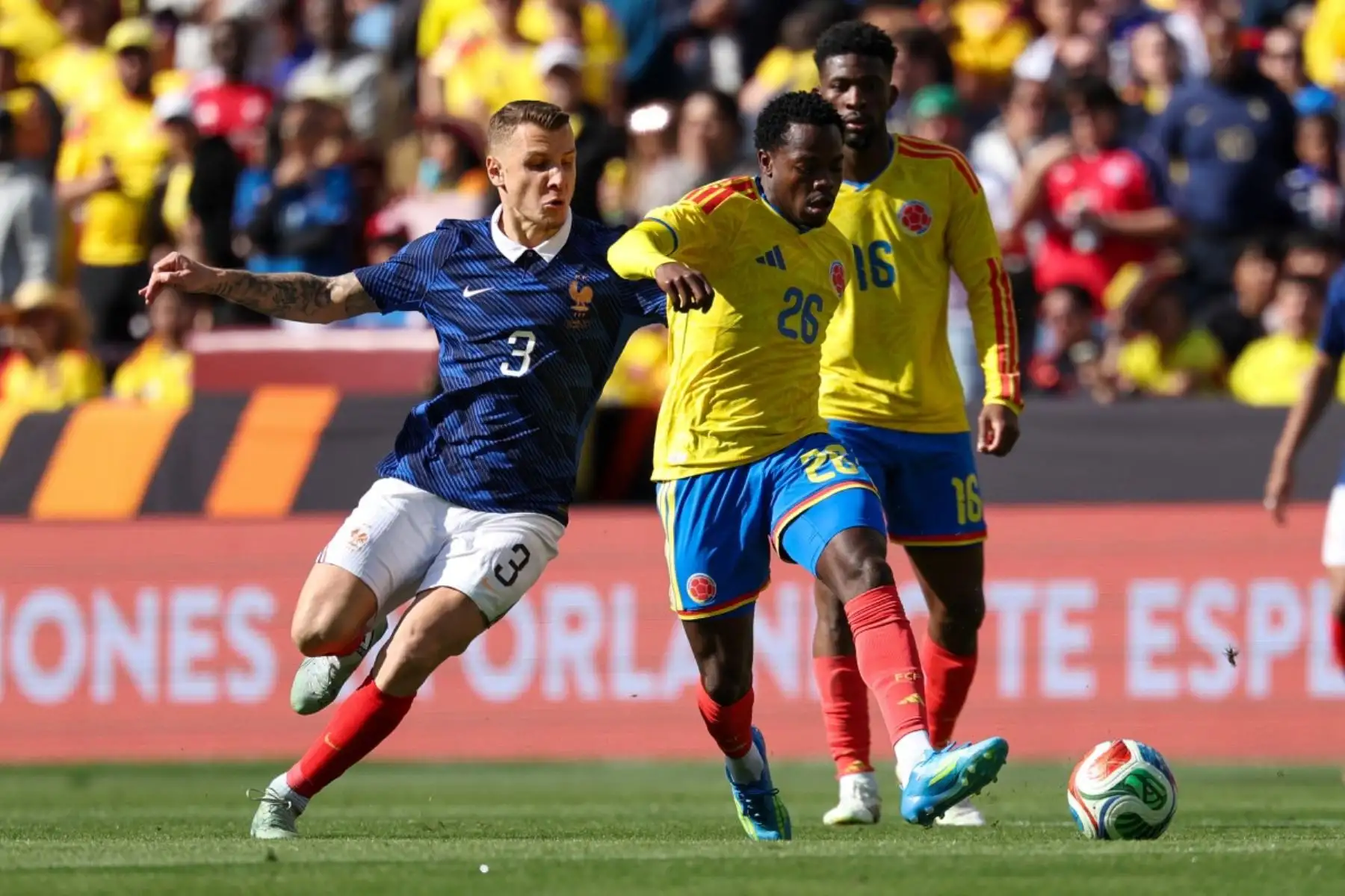 El delantero colombiano Andrés Gómez (número 26) y el defensa francés Lucas Digne (número 3) disputan el balón durante un partido amistoso entre Colombia y Francia en el Northwest Stadium de Landover, Maryland, el 29 de marzo de 2026. (Foto de FRANCK FIFE / AFP)