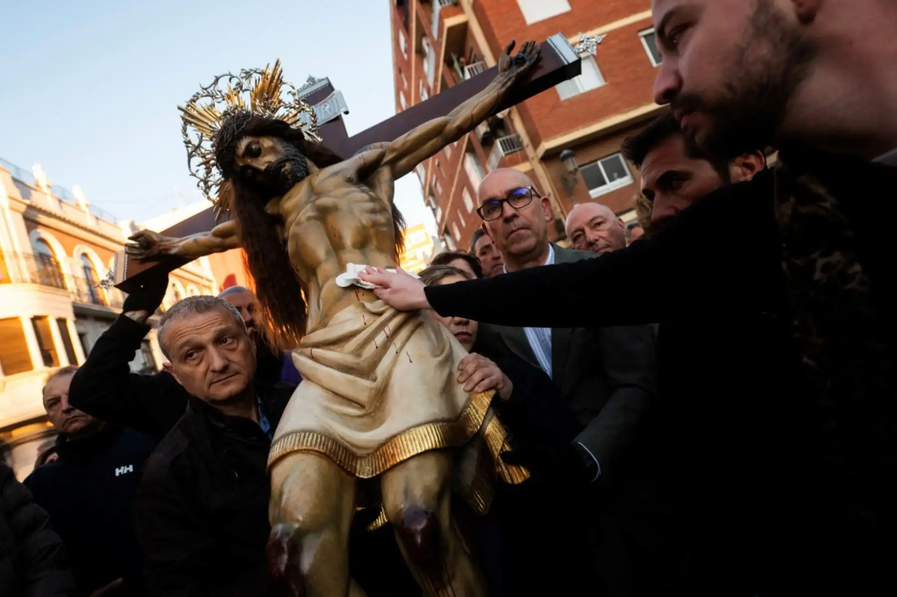 Un creyente toca una efigie del "Cristo Salvador" durante una procesión de la Semana Santa en Valencia el 3 de abril de 2026. Los creyentes cristianos de todo el mundo marcan la semana santa de Pascua en celebración de la crucifixión y resurrección de Jesucristo. (Foto de Jose Jordan / AFP)