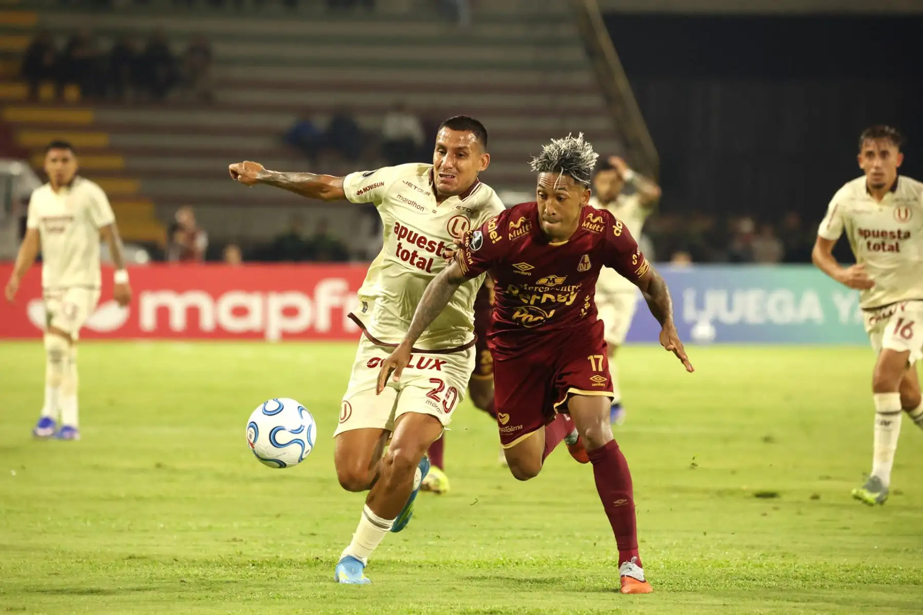 Cristian Arrieta  de Tolima disputa el balón con Álex Valera de Universitario este martes, en un partido de la Copa Libertadores entre Tolima y Universitario. EFE