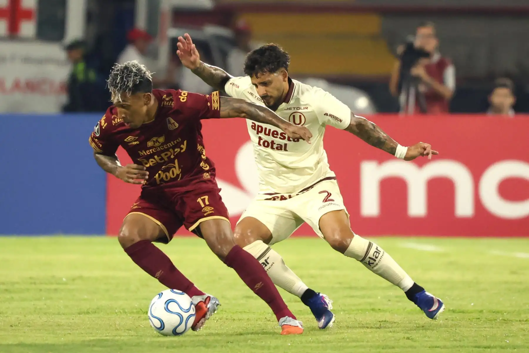 Cristian Arrieta  de Tolima disputa el balón con Caín Fara de Universitario este martes, en un partido de la Copa Libertadores entre Tolima y Universitario. EFE