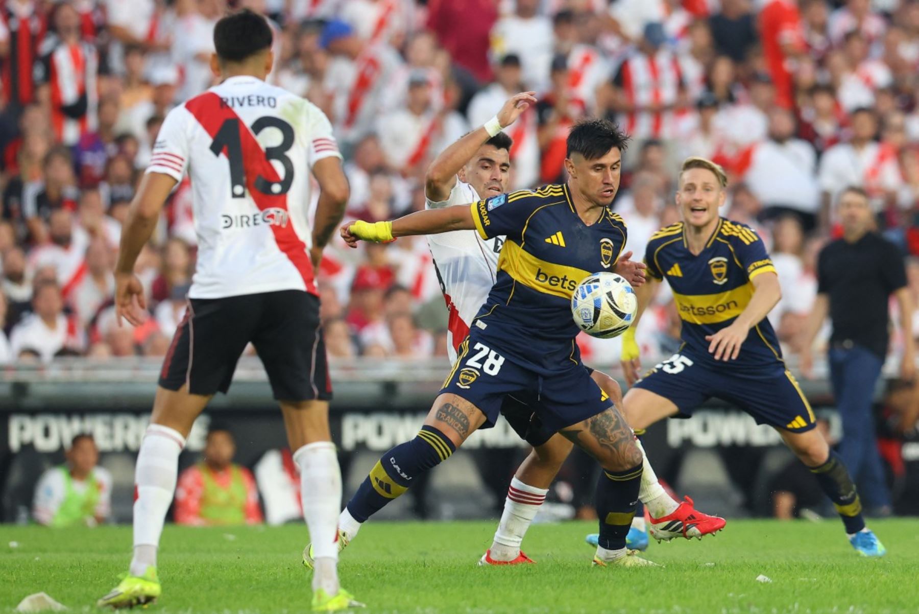 El defensor de River Plate, Marcos Acuña (izq.), número 21, y el delantero paraguayo de Boca Juniors, Adam Bareiro (der.), número 28, luchan por el balón durante el partido del Torneo Apertura 2026 de la Liga Argentina de Fútbol Profesional entre River Plate y Boca Juniors en el estadio MAS Monumental de Buenos Aires, el 19 de abril de 2026. (Foto de Alejandro PAGNI / AFP)