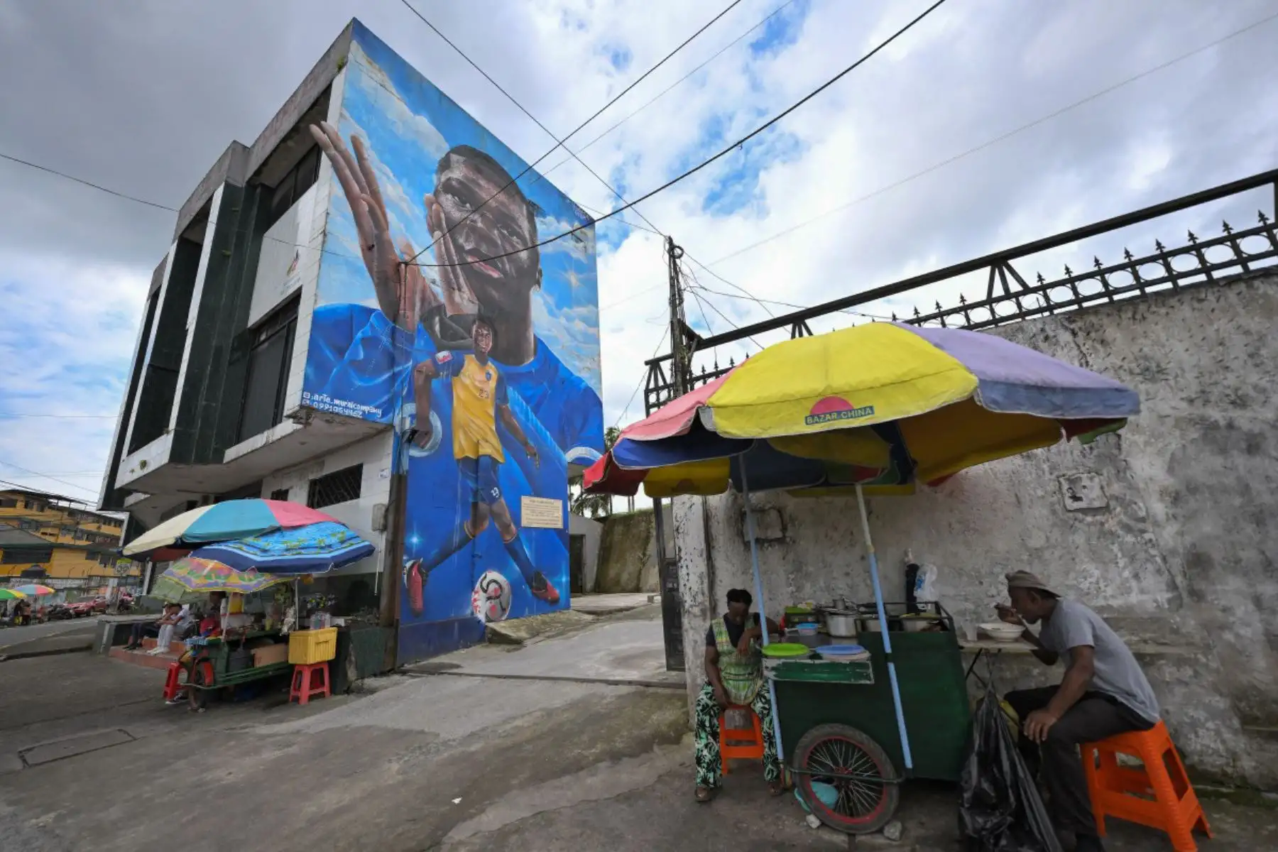 La imagen muestra un mural en honor al futbolista ecuatoriano Moisés Caicedo en el centro de Santo Domingo, Ecuador. En medio de las casas apiñadas de un barrio obrero ecuatoriano, el jugador de la selección nacional, Moisés Caicedo, levantó sus primeros trofeos.  Ahora jugador del Chelsea, disputará su segunda Copa del Mundo con Ecuador. Foto: AFP