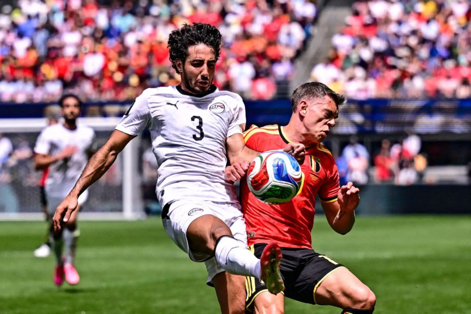 El egipcio Mohamed Hany y el belga Leandro Trossard luchan por el balón durante un partido de fútbol entre la selección belga, los Diablos Rojos, y Egipto, el lunes 15 de junio de 2026 en Seattle. Este fue el primer partido de la fase de grupos de la Copa Mundial de la FIFA 2026. Foto: ANDINA/AFP
