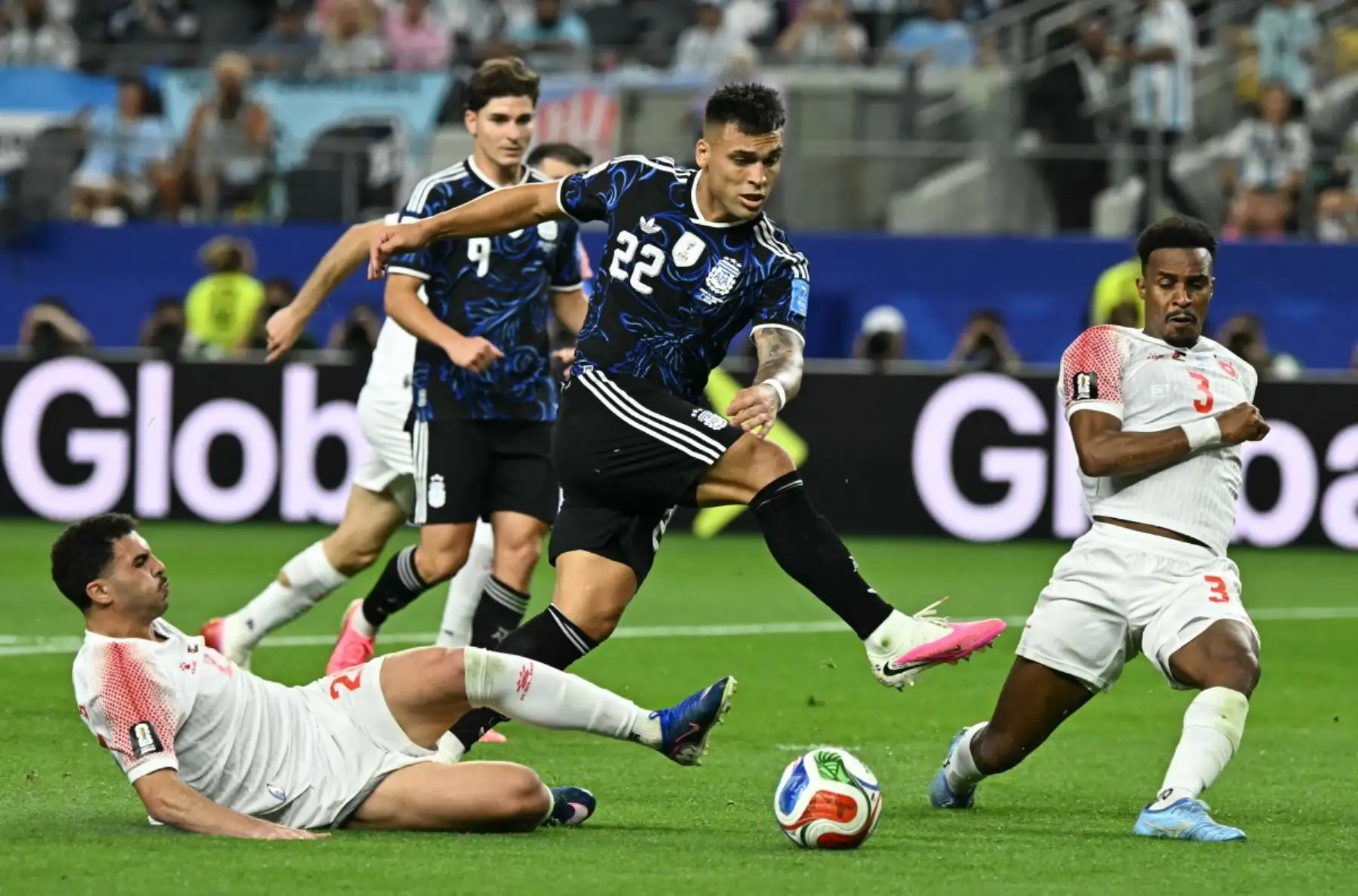 El centrocampista jordano Mohannad Abu Taha (número 20), el delantero argentino Lautaro Martínez (número 22) y el defensa jordano Abdallah Nasib (número 3) luchan por el balón durante el partido de fútbol del Grupo J de la Copa Mundial 2026 entre Jordania y Argentina en el Estadio Dallas de Arlington el 27 de junio de 2026. (Foto de Paul ELLIS / AFP)