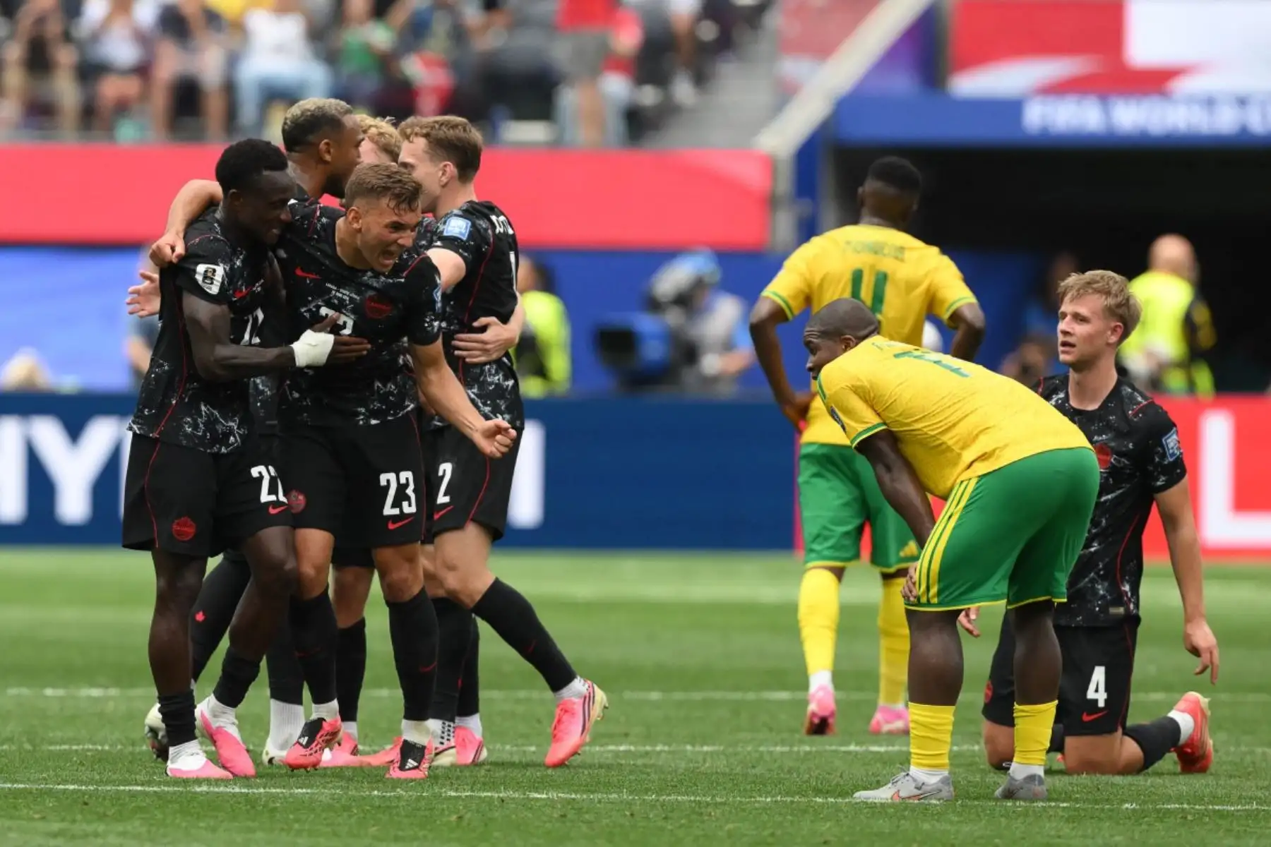 El defensa canadiense Richie Laryea (número 22) y el defensa Niko Sigur (número 23) celebran la victoria de Canadá en el partido de dieciseisavos de final del Mundial de 2026 entre Sudáfrica y Canadá, disputado en el estadio de Los Ángeles en Inglewood el 28 de junio de 2026. (Foto de Patrick T. Fallon / AFP)