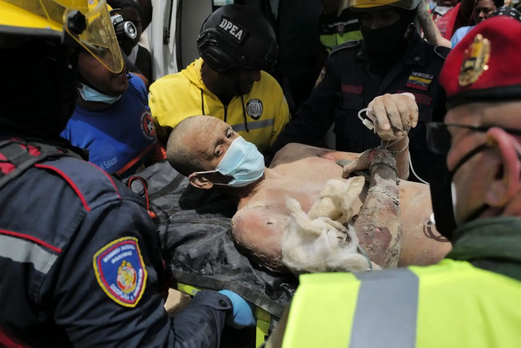 Los rescatistas suben a una persona a una ambulancia tras ser rescatada con vida de entre los escombros de un edificio derrumbado en Caraballeda, estado de La Guaira, Venezuela, el 28 de junio de 2026, tras los terremotos. Foto: AFP