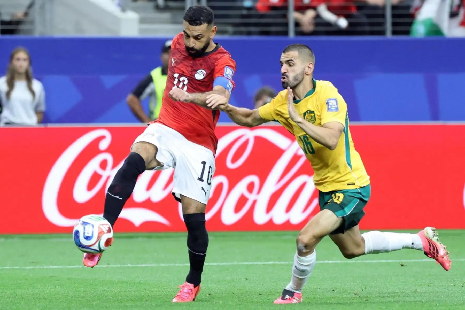 El delantero egipcio número 10, Mohamed Salah (izquierda), disputa el balón con el defensa australiano número 16, Aziz Behich, durante el partido de dieciseisavos de final del Mundial de 2026 entre Australia y Egipto, disputado en el estadio Dallas de Arlington el 3 de julio de 2026. (Foto de Thomas COEX / AFP)