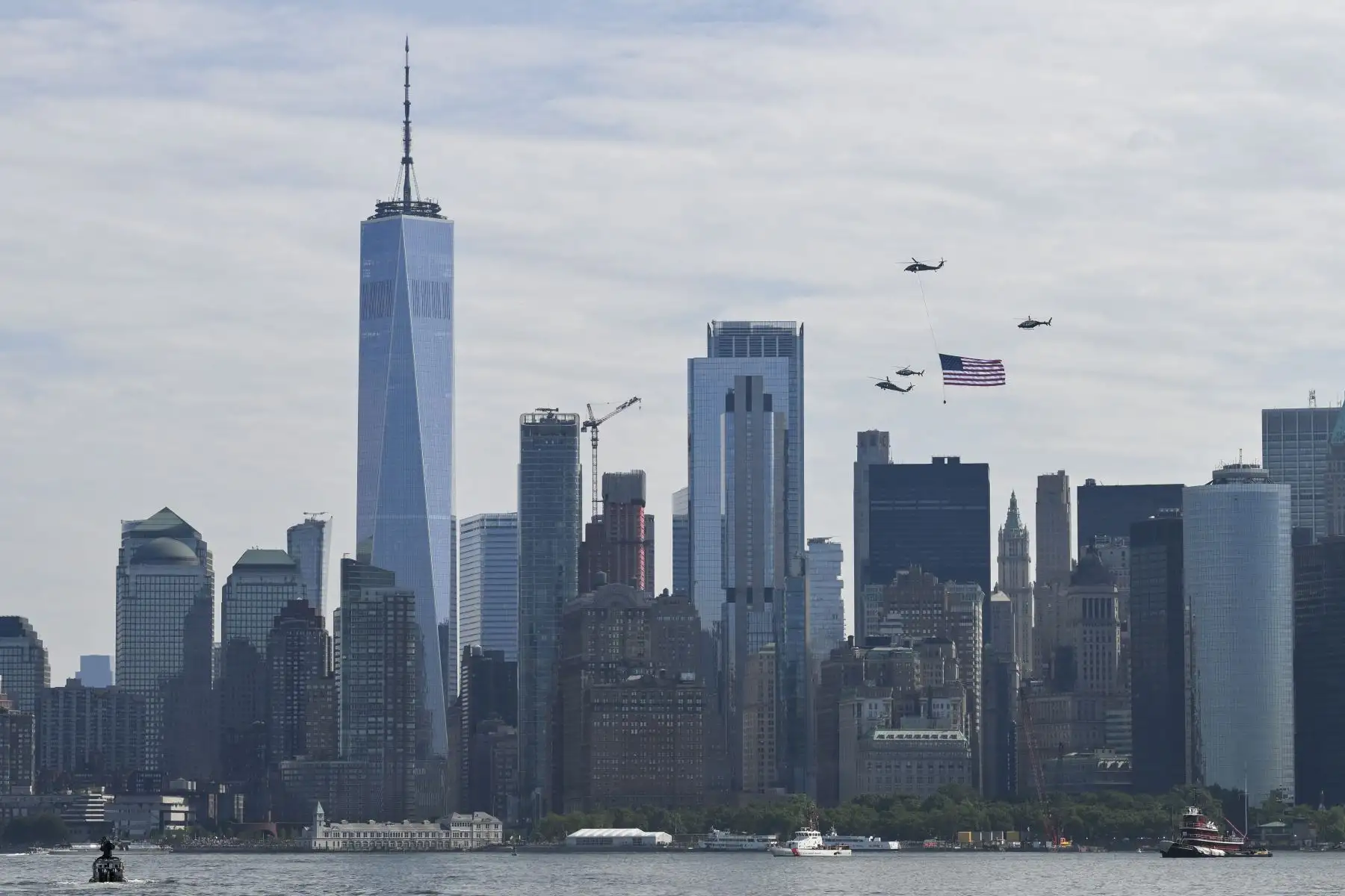 Unos helicópteros ondean la bandera de Estados Unidos encabezando el desfile de barcos «Sail4th 250» en el puerto de Nueva York, con motivo del 250 aniversario del país en el Día de la Independencia, el 4 de julio de 2026. Foto: AFP