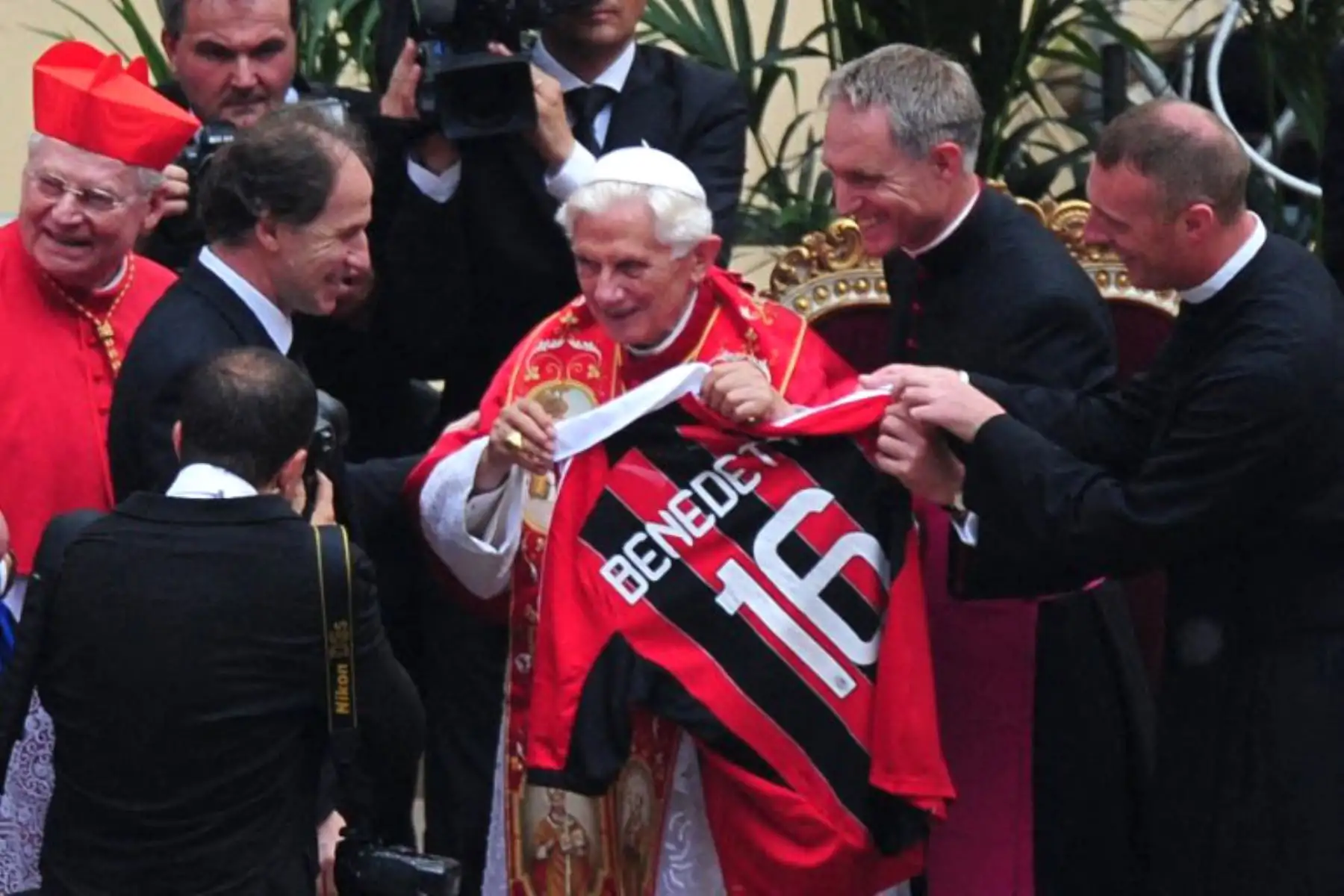 El Papa Benedicto XVI recibe una camiseta del AC Milan con su nombre y el número 16 de manos del excapitán del AC Milan, Franco Baresi (I), durante una celebración con candidatos a la Confirmación en el estadio San Siro de Milán, en el marco del VII Encuentro Mundial de las Familias, el 2 de junio de 2012. Foto: AFP
