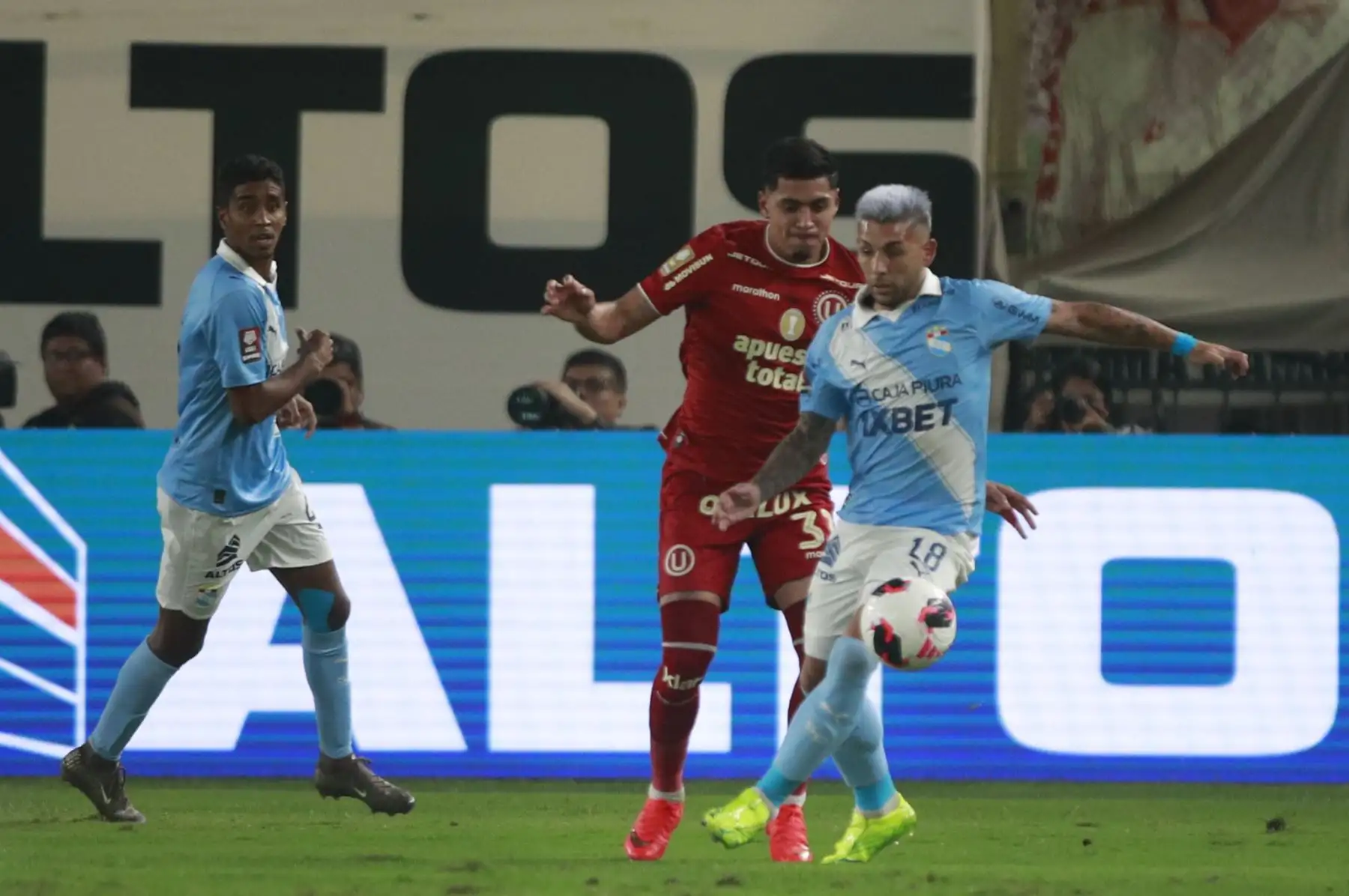 Jairo Concha de Universitario disputa el balón con el futbolista Juan Cruz González de Sporting Cristal, durante el partido perteneciente a la cuarta fecha del Torneo Clausura, en el Estadio Monumental de Lima. Foto: ANDINA/Ricardo Cuba