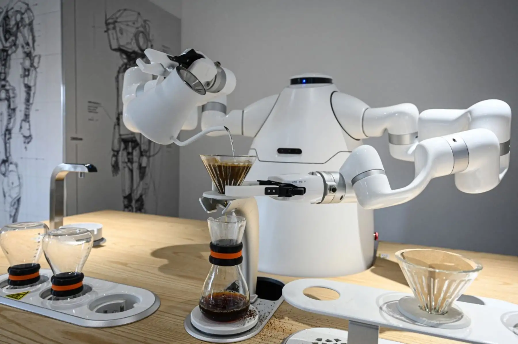 Esta foto, tomada el 4 de agosto de 2026, muestra un robot fabricado por el Instituto de Investigación Robótica de la Universidad de Zhejiang preparando café en la Escuela de Robótica de Hangzhou, en la provincia de Zhejiang, al este de China. (Foto de Jade GAO / AFP)