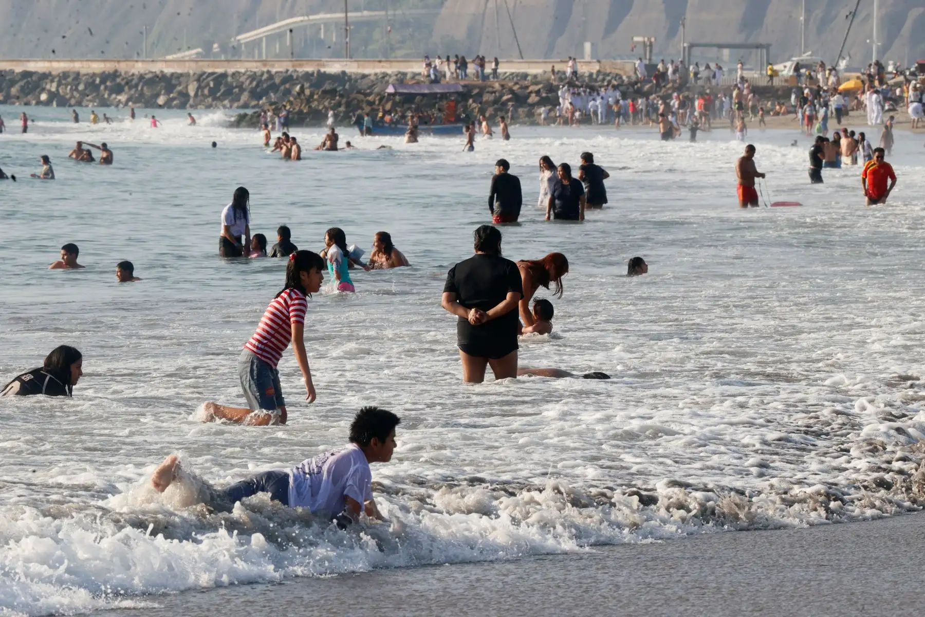 Con temperaturas máximas de 24°C en la ciudad de Lima, y pese al aumento de vientos fríos y precipitaciones en los últimos días, los peruanos continuan disfrutando del sol, la arena y el mar en los balnearios de la capital, tal como ocurrió hoy sábado 22 de agosto de 2026 en la playa Agua Dulce de Chorrillos, con una masiva concurrencia. Foto: ANDINA/Vidal Tarqui
