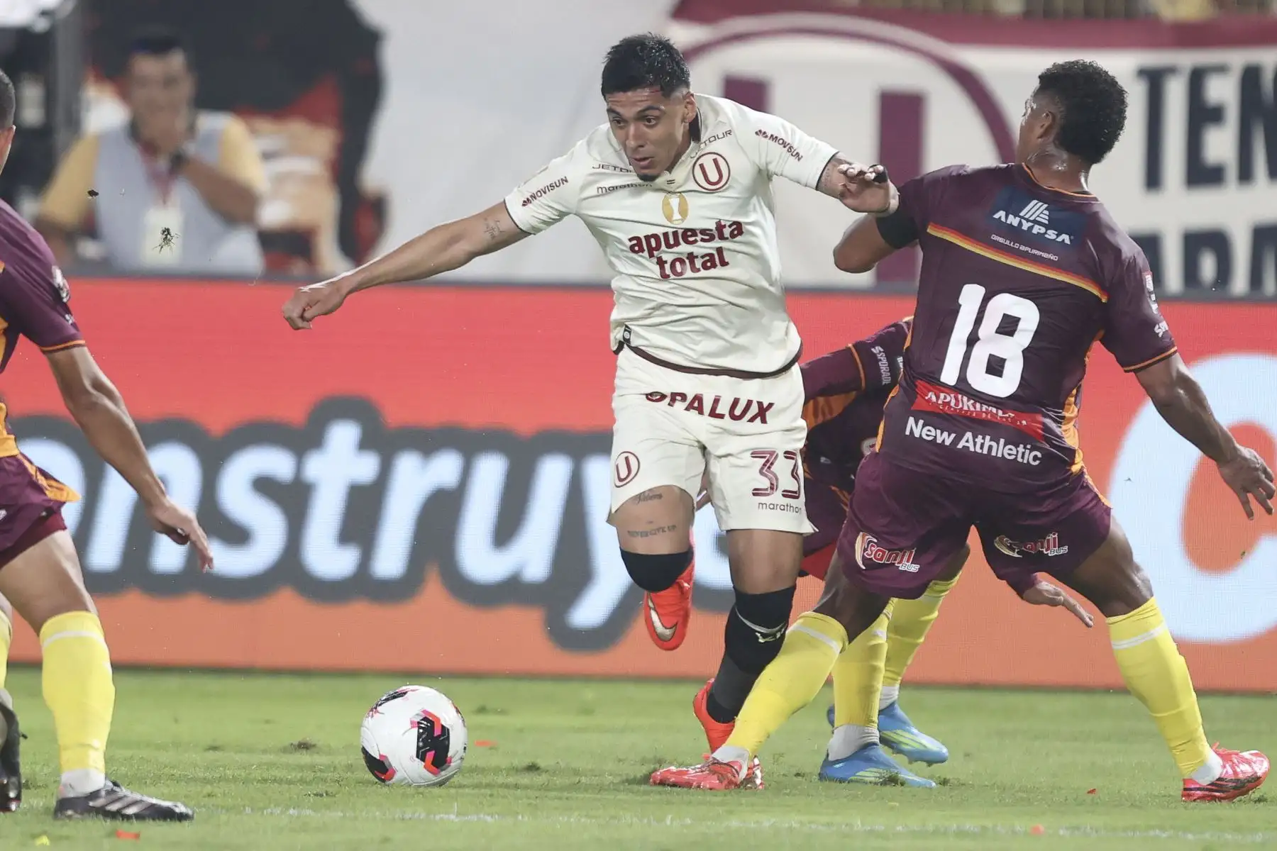 El futbolista Nro. 33 de Universitario, César Inga, disputa el balón con el jugador Nro. 18 de Chankas, Oshiro Takeuchi, durante el partido de la fecha 6 del Torneo Clausura 2026 de la Liga 1, disputado en el Estadio Monumental U de Ate el domingo 23 de agosto. Foto: ANDINA/Jhonel Rodríguez
