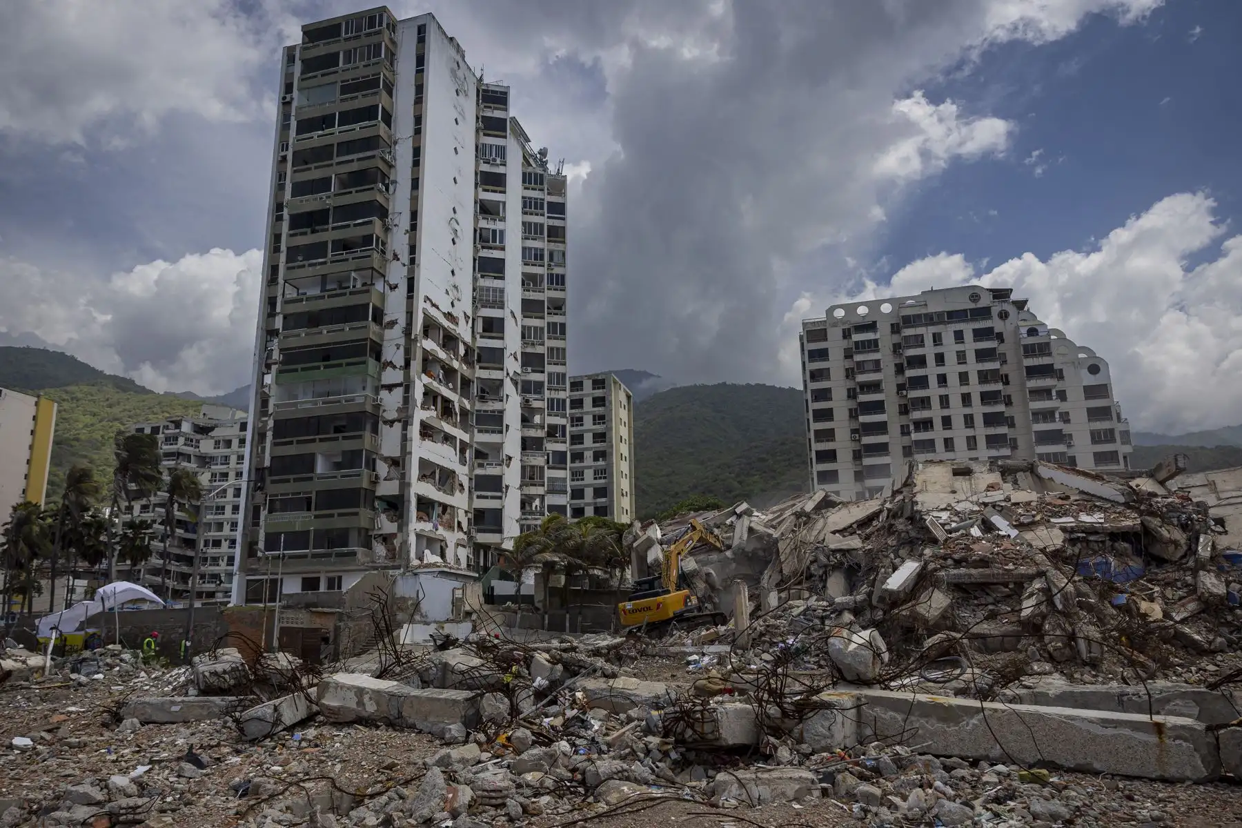 Maquinaria pesada remueve escombros este lunes, en edificios afectados por el doble terremoto del 24 de junio, en Caraballeda (Venezuela). Foto: EFE