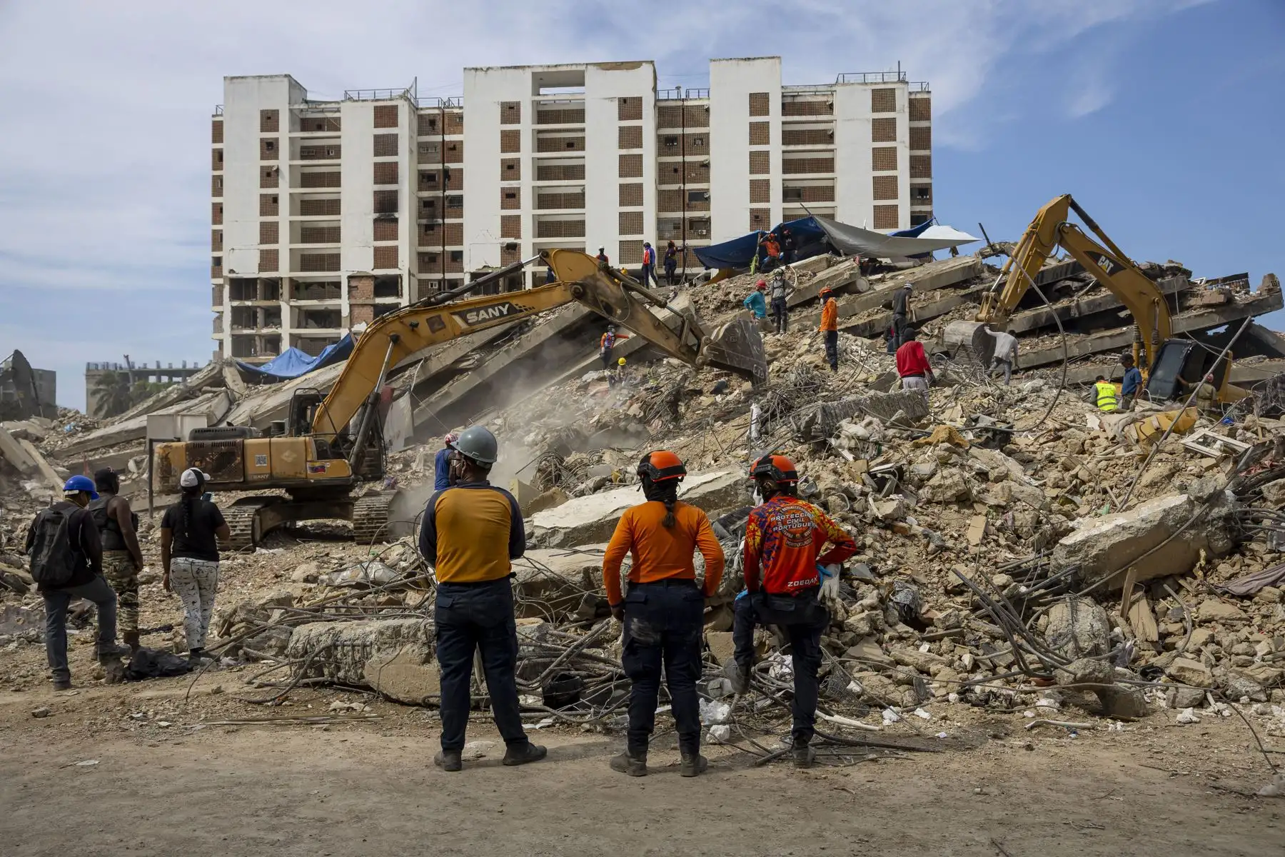 Voluntarios y autoridades remueven escombros este lunes, en edificios afectados por el doble terremoto del 24 de junio, en Caraballeda (Venezuela). Foto: EFE
