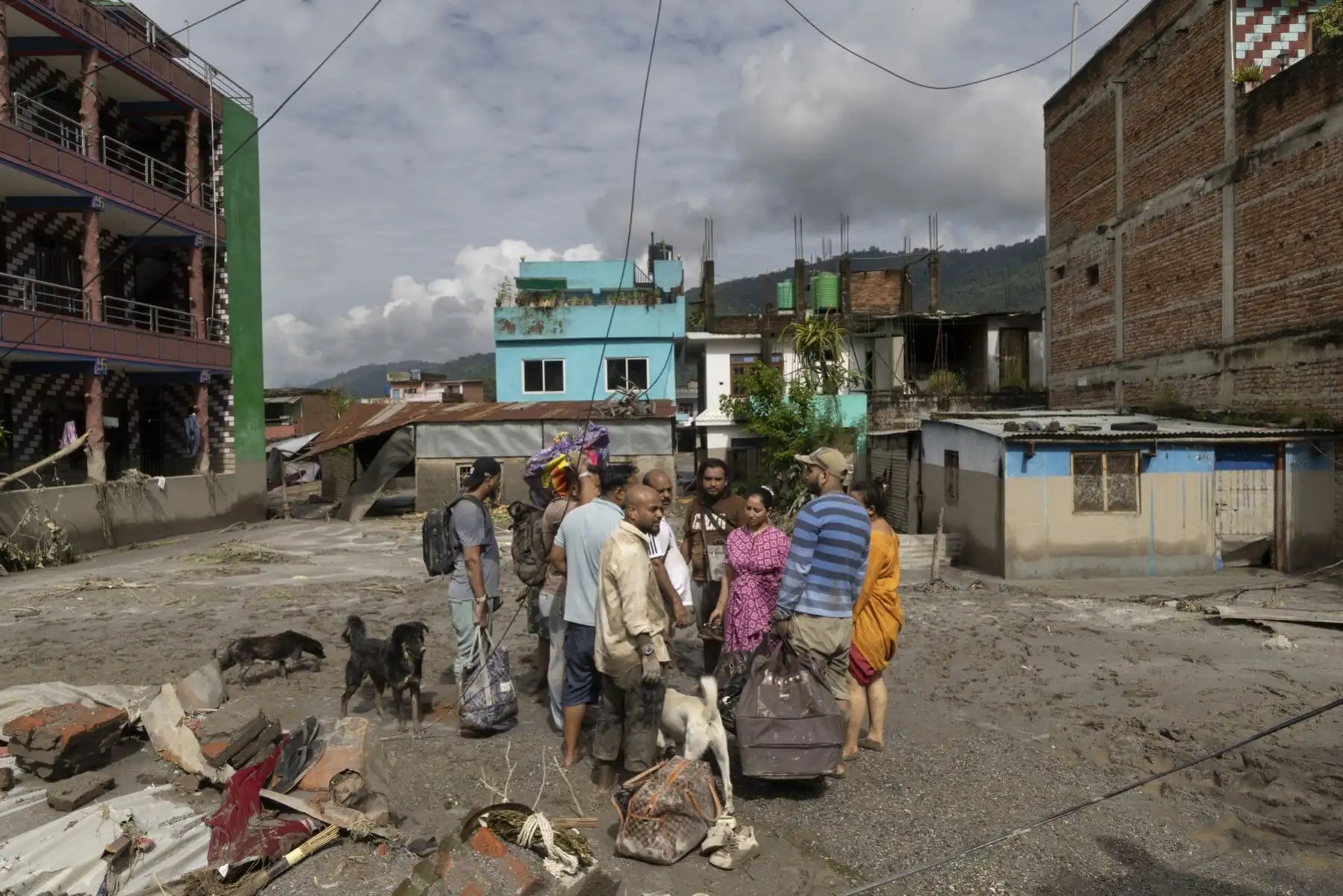 Sobrevivientes de inundaciones regresan a sus hogares tras una crecida repentina en la aldea de Devighat, distrito de Nuwakot, Nepal. Foto: EFE