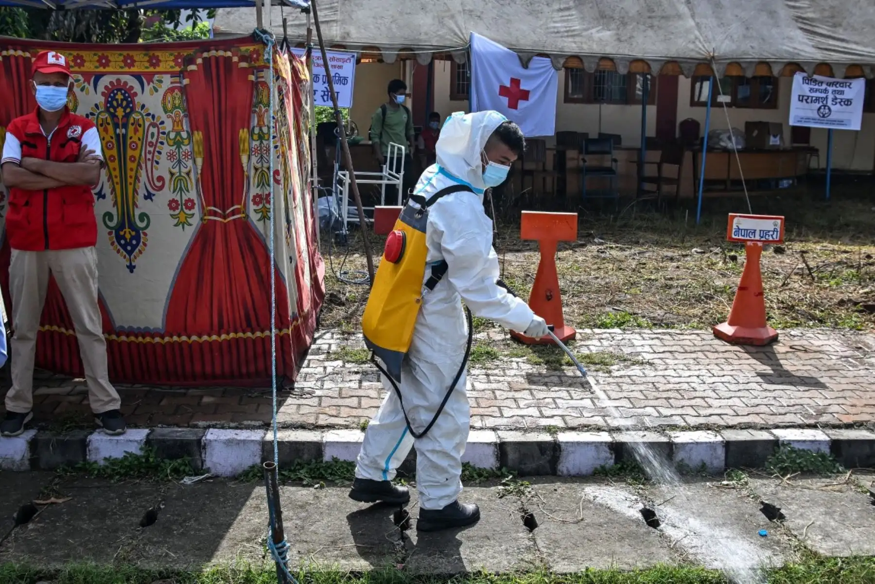Un trabajador sanitario desinfecta la zona exterior de una morgue en Bharatpur, en el distrito de Chitwan de Nepal, el 30 de agosto de 2026. Foto: AFP