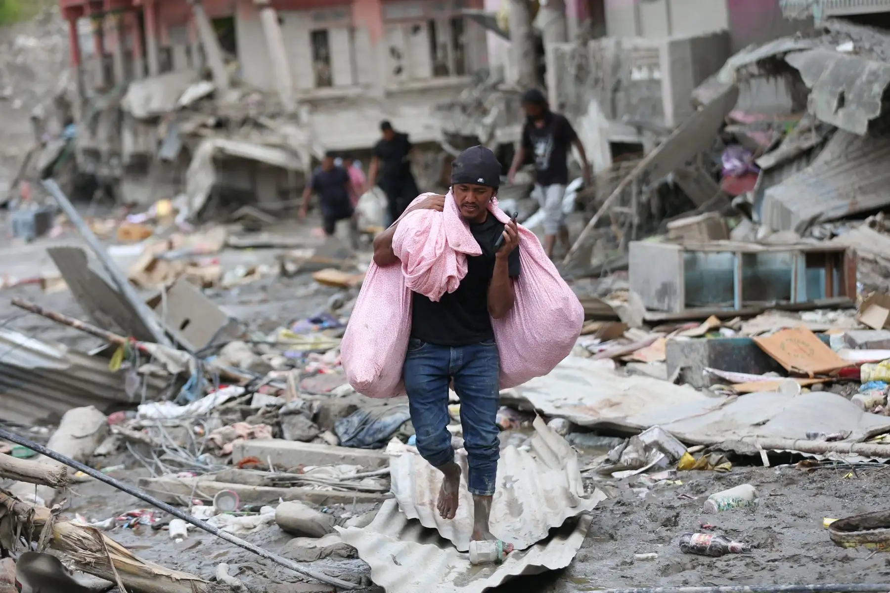 Un hombre recoge pertenencias personales en una comunidad afectada por una inundación de origen glaciar cerca de la frontera entre Nepal y China —suceso que causó cientos de víctimas mortales— en Trishuli Bazar, Nuwakot, Nepal. Foto: EFE