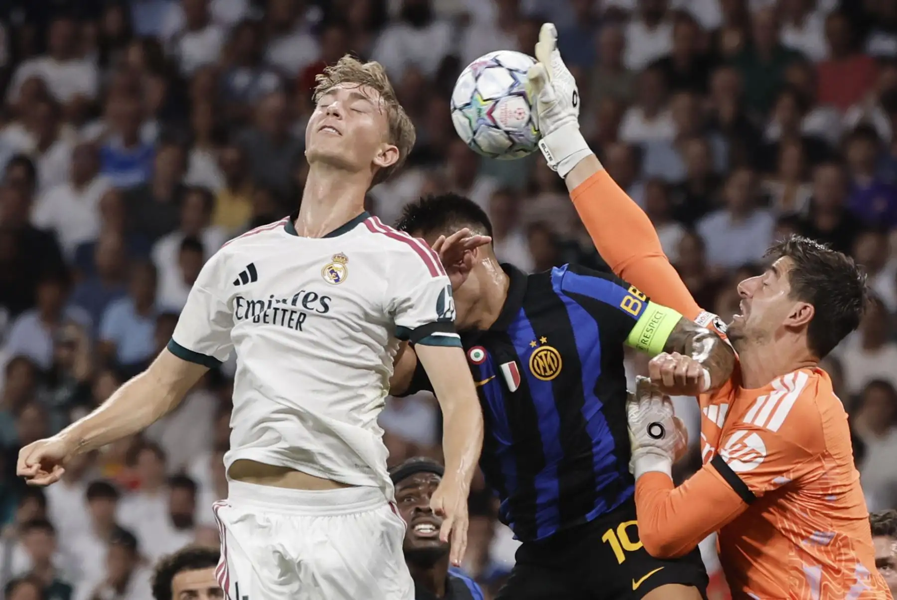 l guardameta del Real Madrid Thibaut Courtois (d) lucha con el argentino Lautaro Martínez, del Inter, durante el encuentro correspondiente a la Liga de Campeones que disputan Real Madrid e Inter de Milán, este martes en el estadio Santiago Bernabéu, en Madrid. Foto: EFE