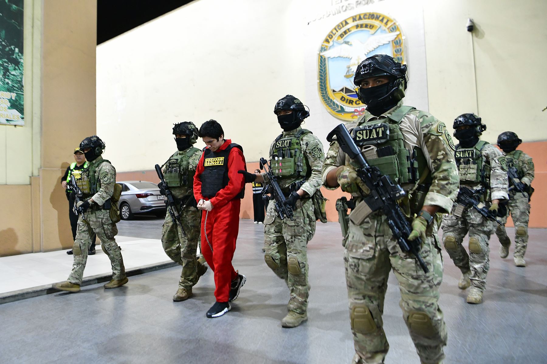 Un grupo de policías escoltando a Jhonsson Cruz Torres (c), principal líder de la banda criminal peruana Los Pulpos, y conocido bajo el apodo de 