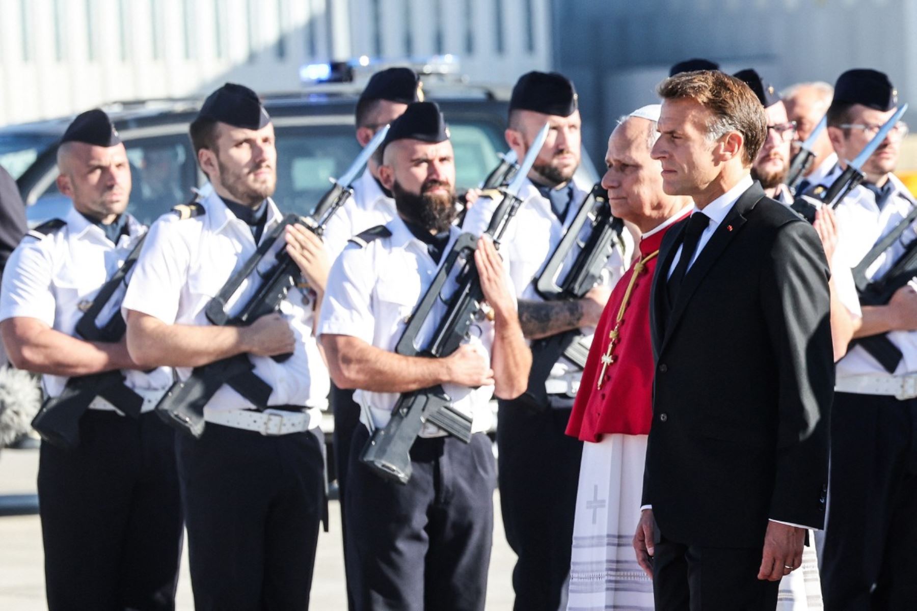 El papa León XIV y el presidente de Francia, Emmanuel Macron, pasan revista a una guardia de honor en la pista tras descender del avión a su llegada al aeropuerto de Orly, a las afueras de París. Foto: AFP