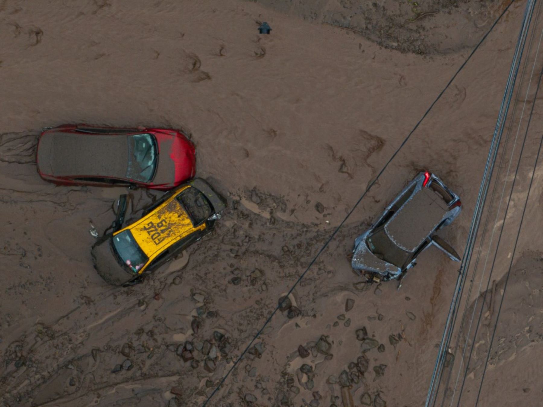 Objetos personales y mobiliario quedaron atrapados entre el barro luego del aluvión que avanzó por calles residenciales de Las Condes, en Santiago de Chile. Foto: AFP